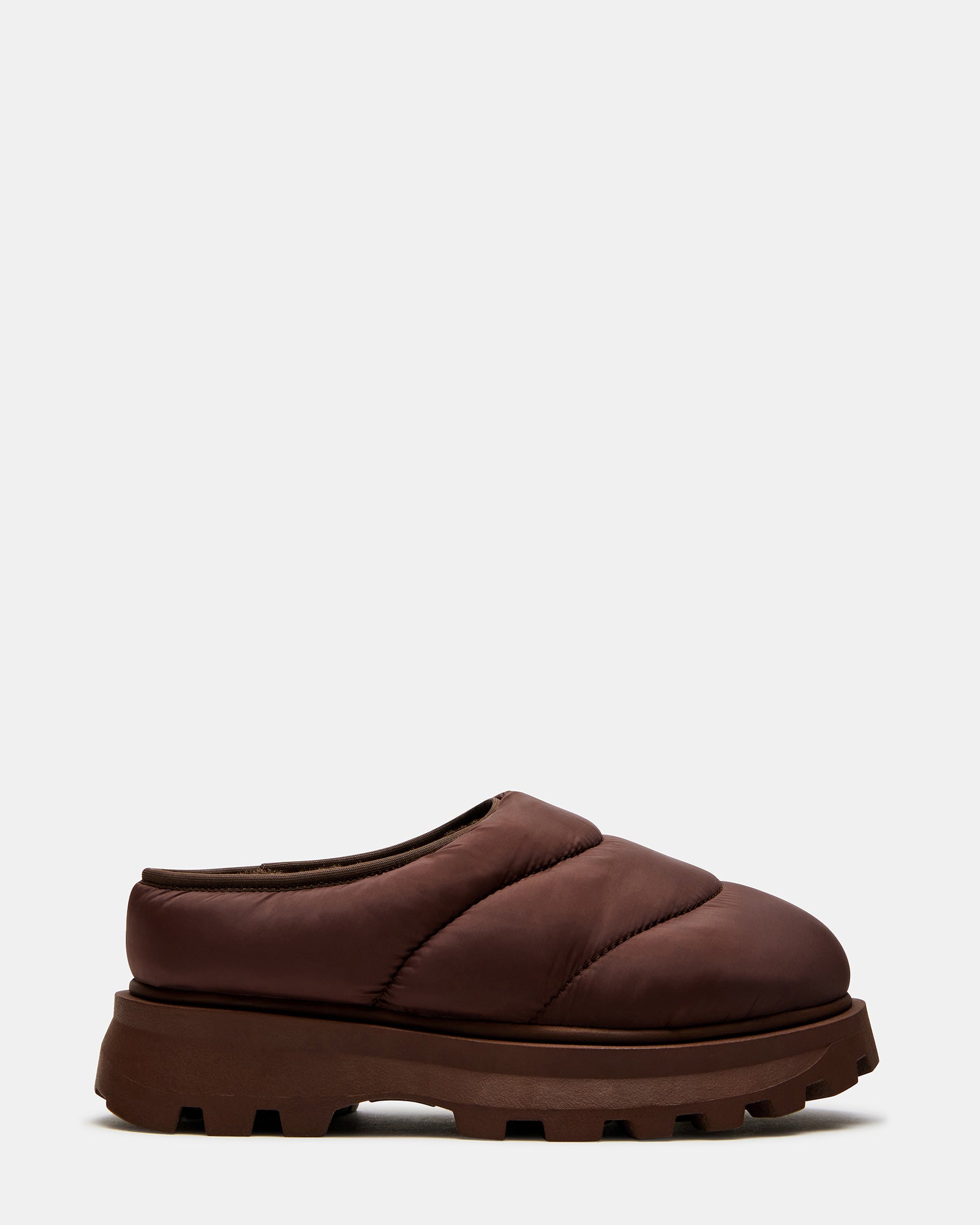 Frost Brown slip-on shoes on a wooden bench, showcasing the faux fur lining