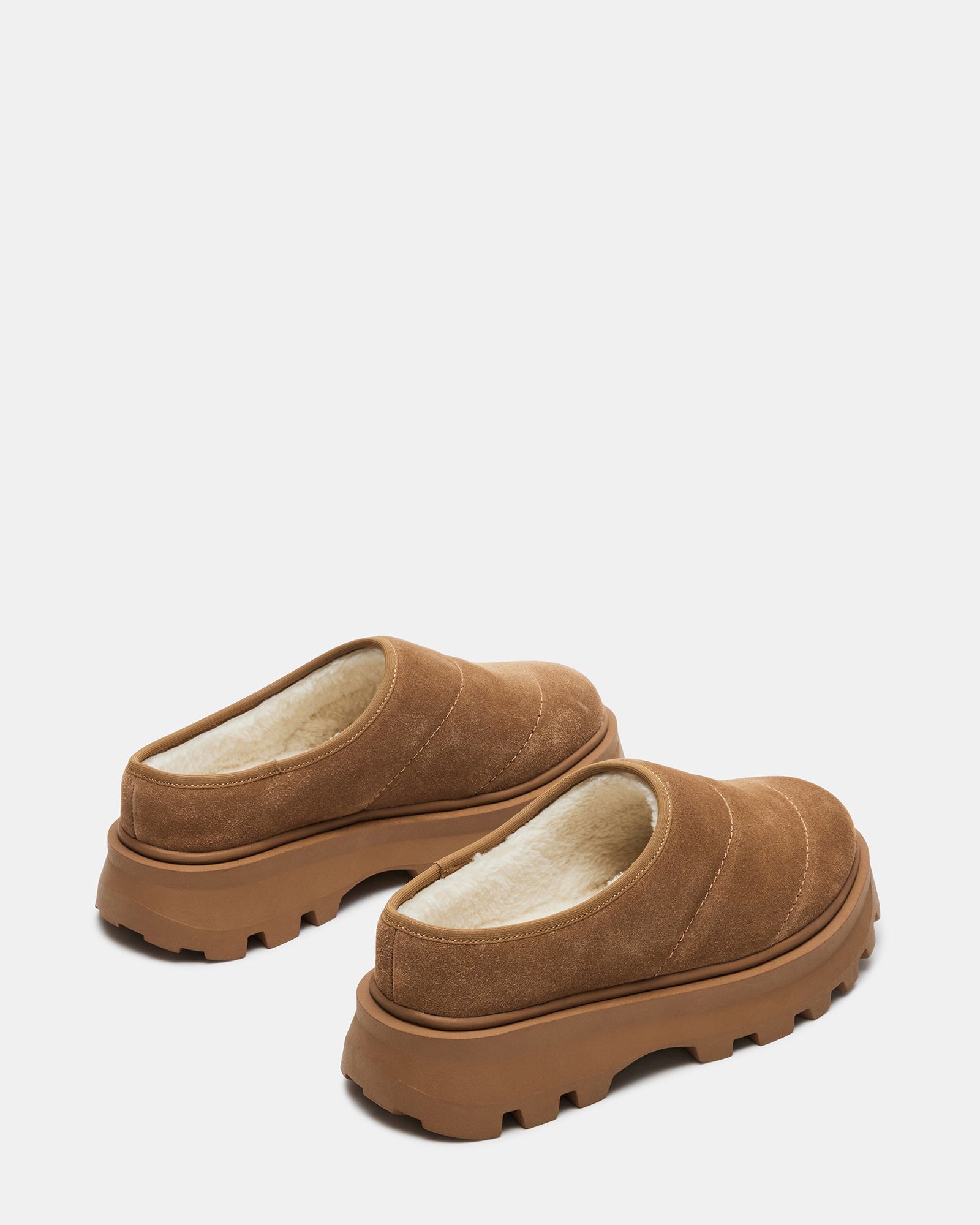Close-up of suede upper and faux fur lining on womens slip-on shoes