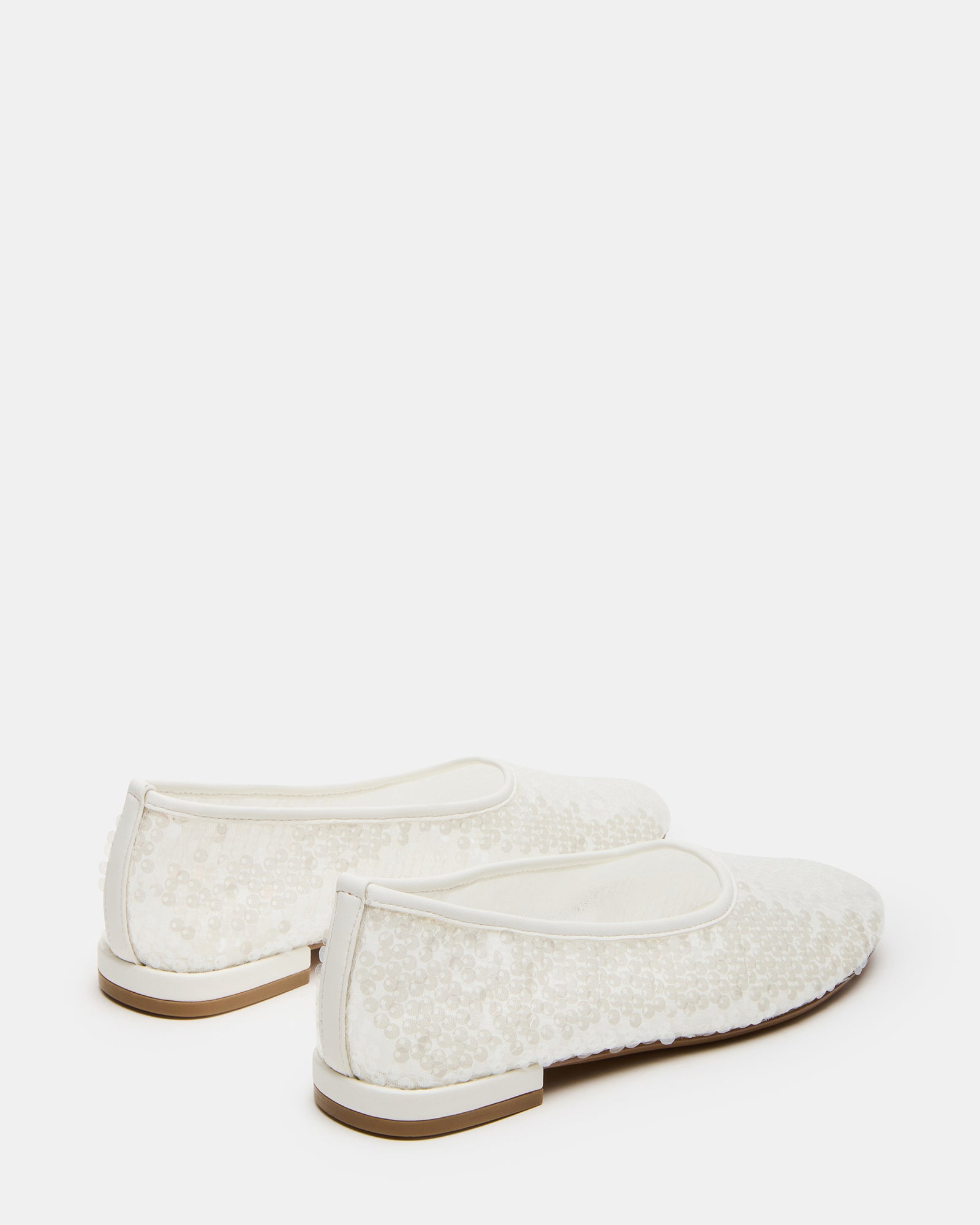 Garcelle ballet flats worn with casual outfit in a street setting.