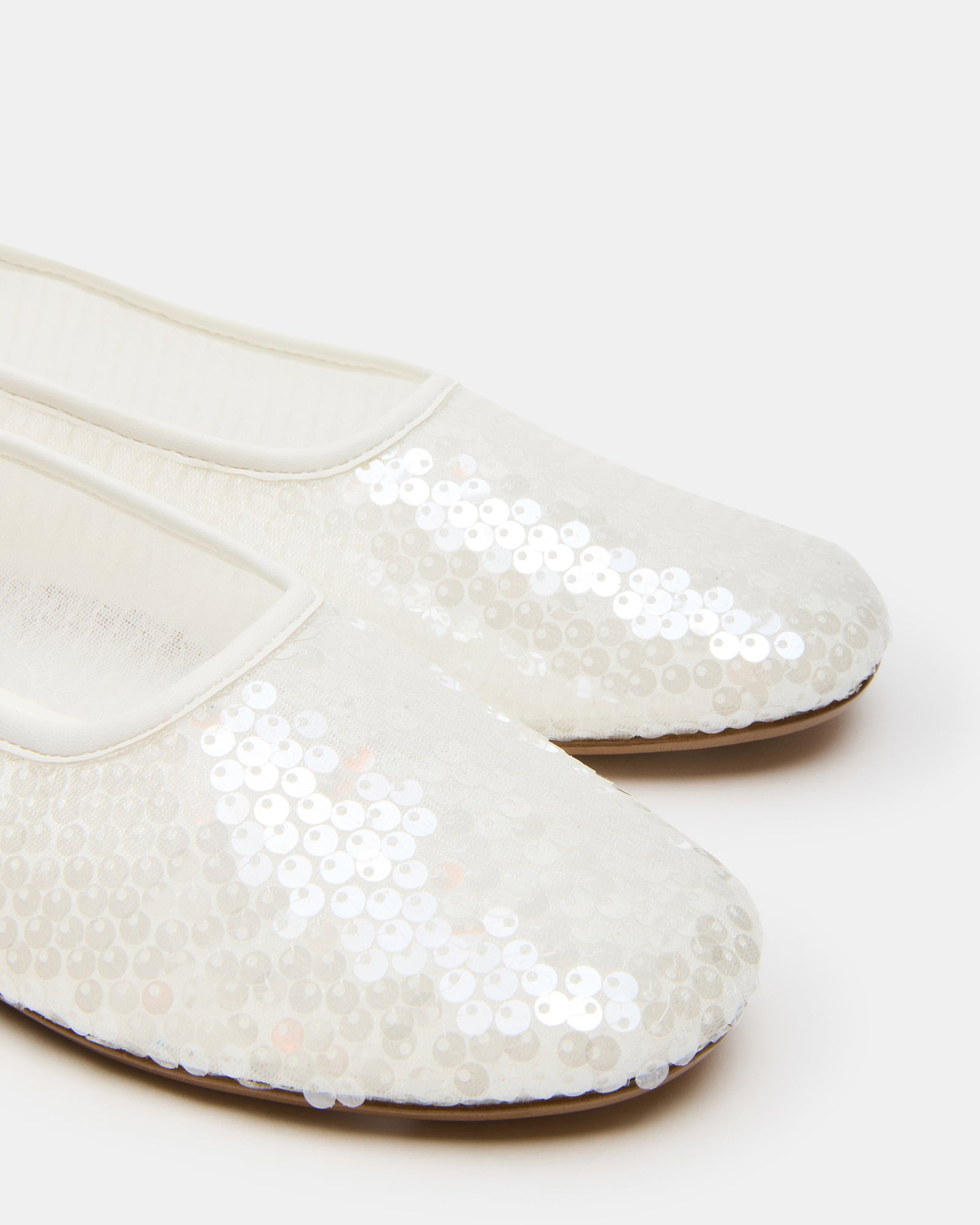 Elegant black ballet flats showcased on a stylish display.