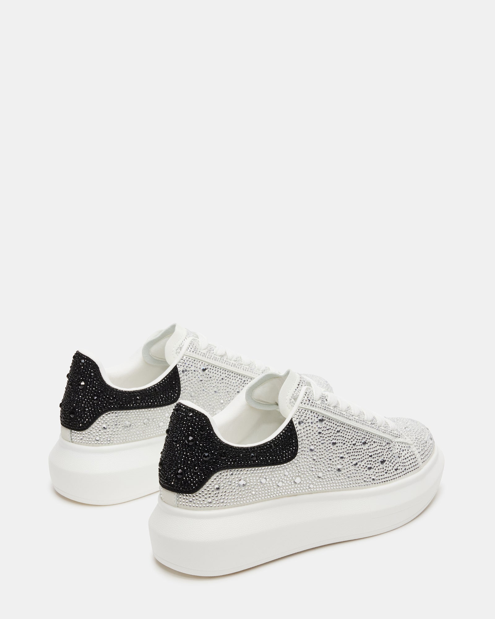 Side angle showing black platform sneakers with shimmer details