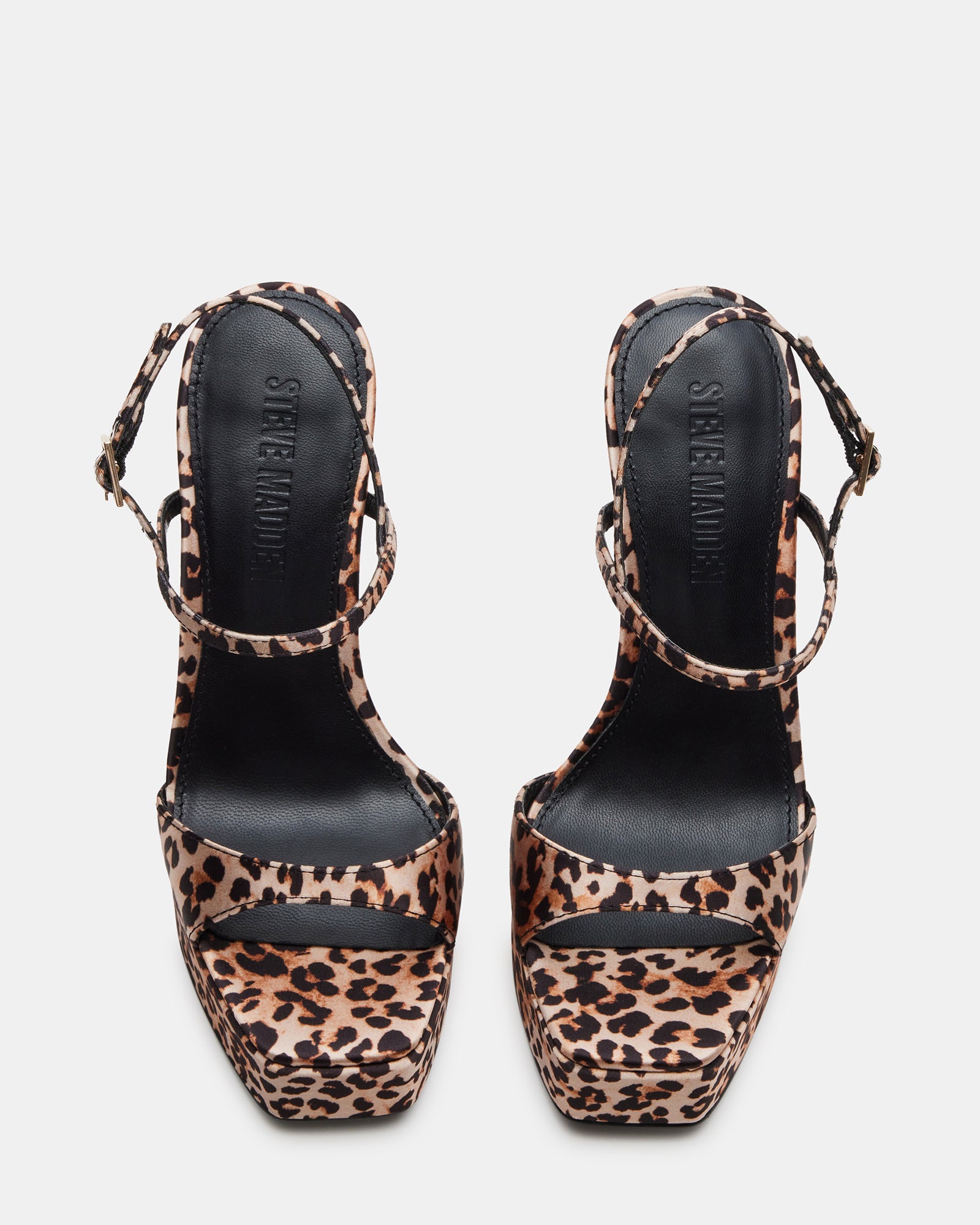 Side angle of nude high heel sandals with ankle strap on rooftop setting