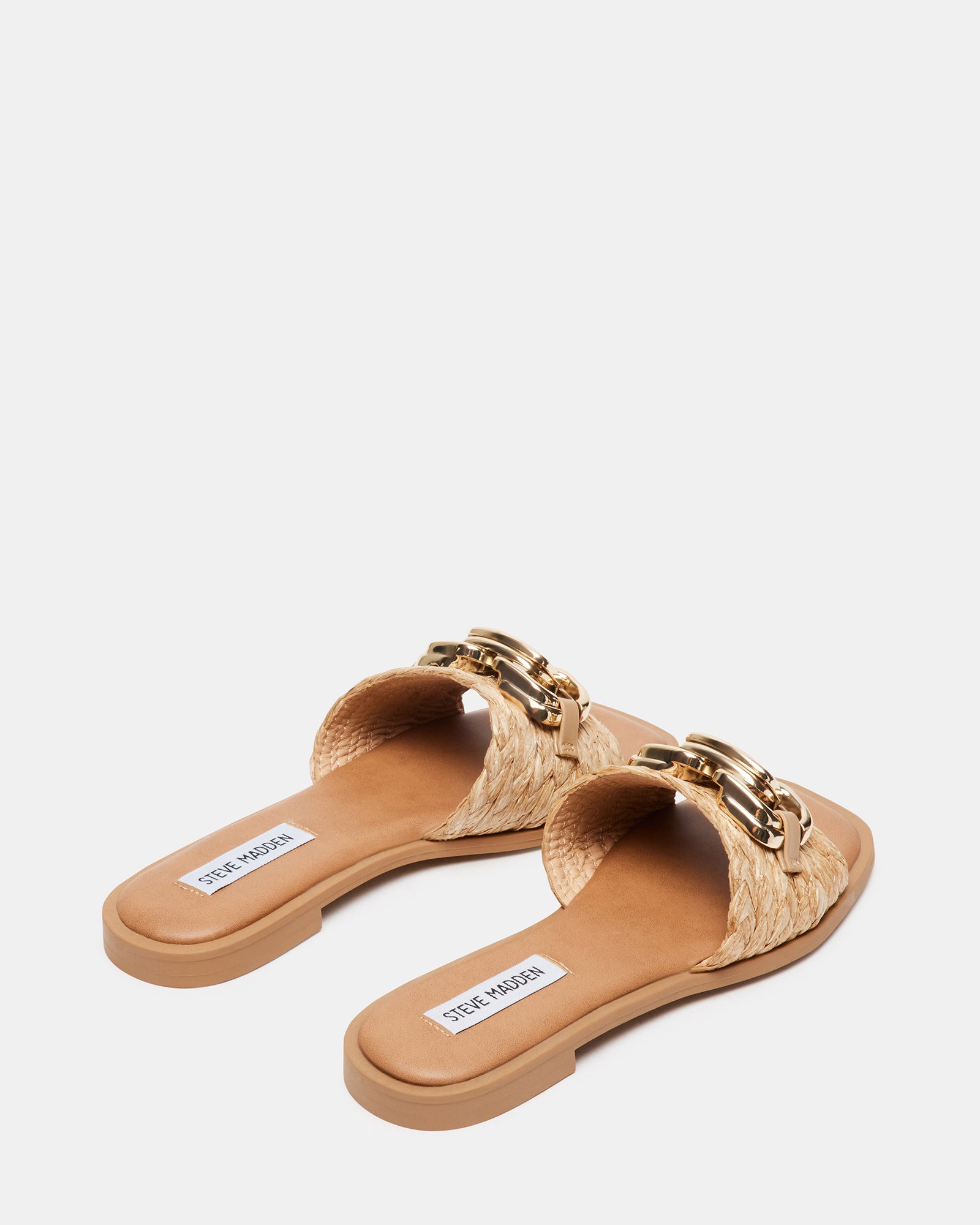 Casual outdoor scene featuring women wearing Gene Raffia flat slide sandals