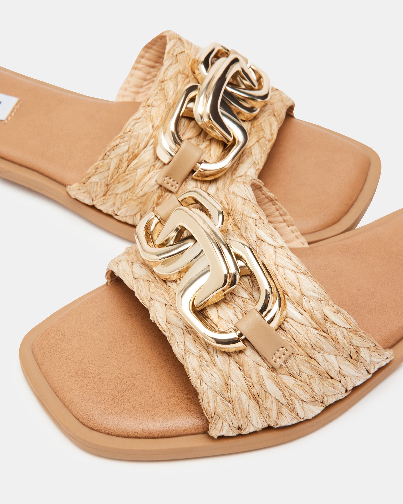 Close-up of the wide front strap with chain hardware on Gene Raffia sandals