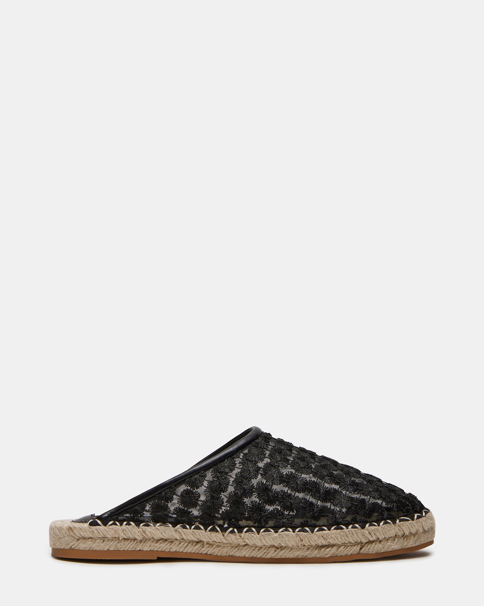 Side view of stylish flat black mules shoes showcasing the rounded toe design.