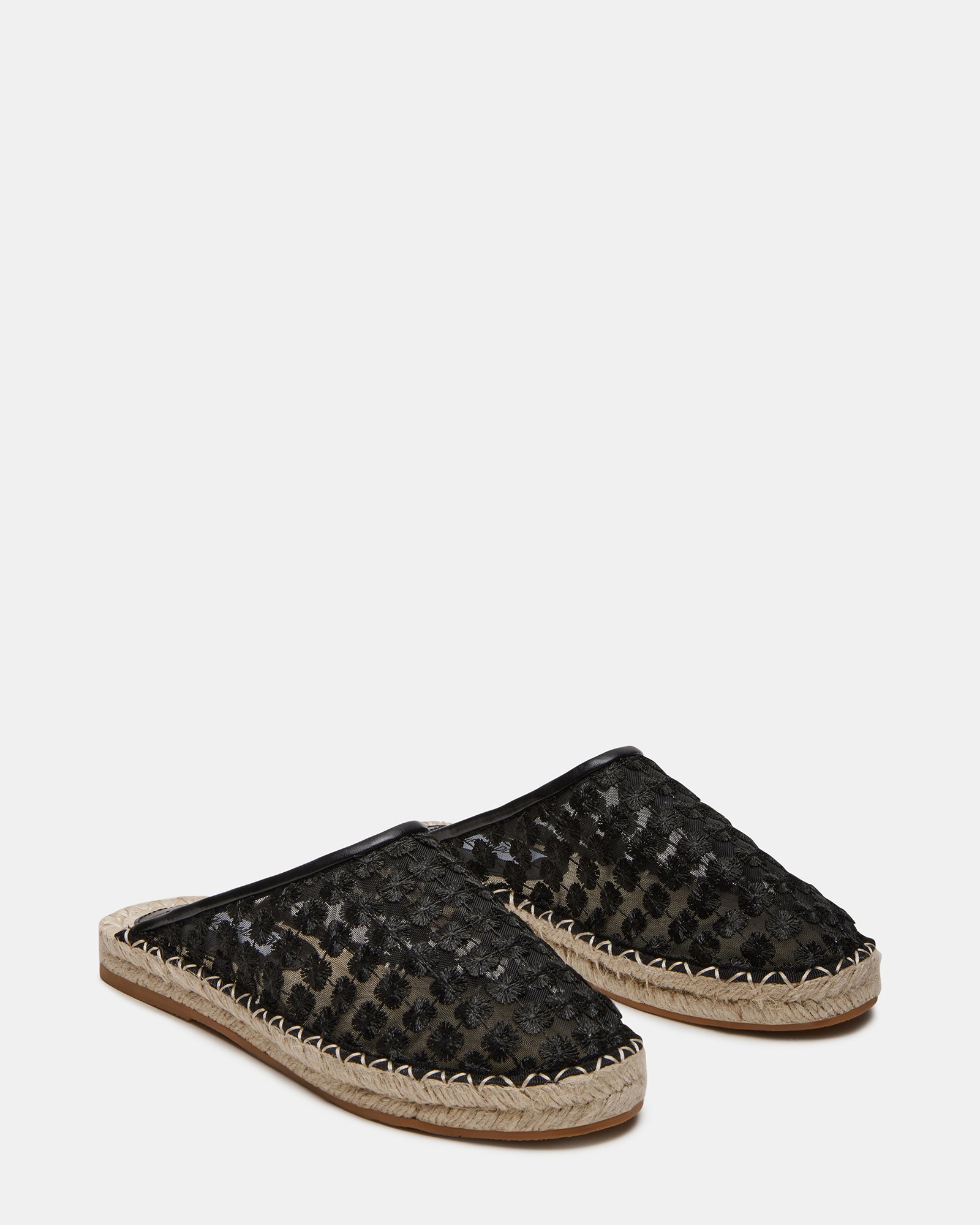 Top view of slip-on loafer mules highlighting the vegan leather texture.