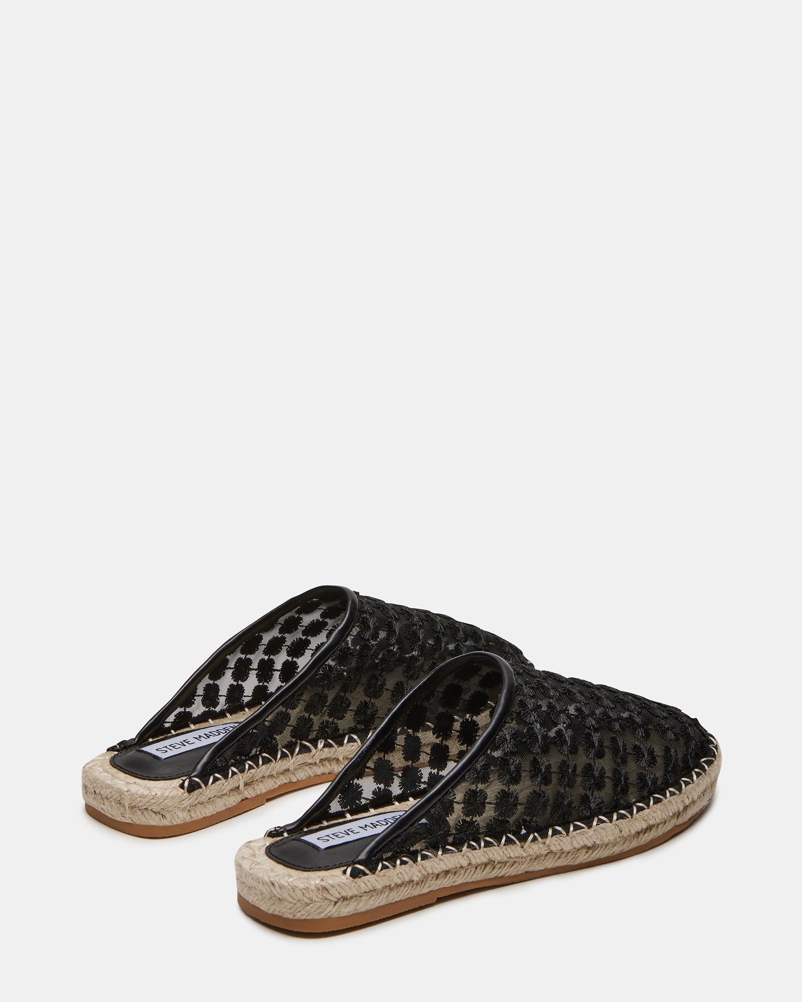 Top view of slip-on loafer mules highlighting the vegan leather texture.