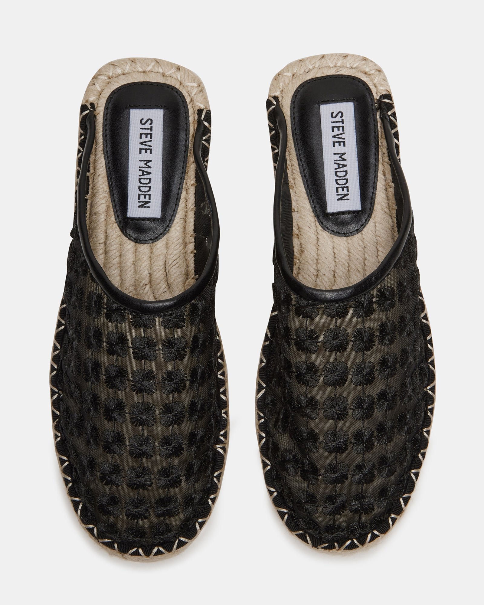 Side view of stylish flat black mules shoes showcasing the rounded toe design.