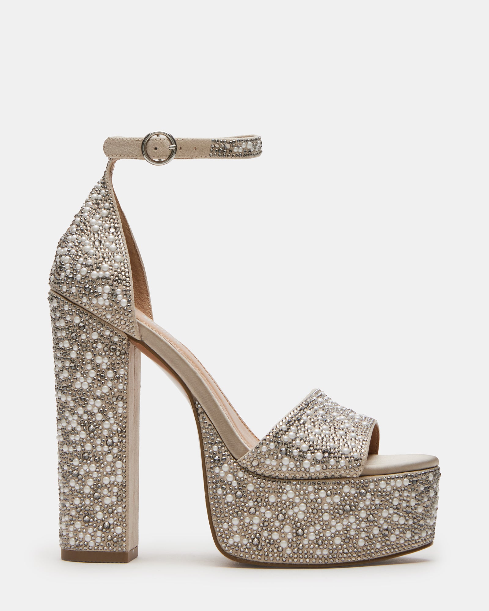 Ivory platform heels with ankle strap, worn with a black dress