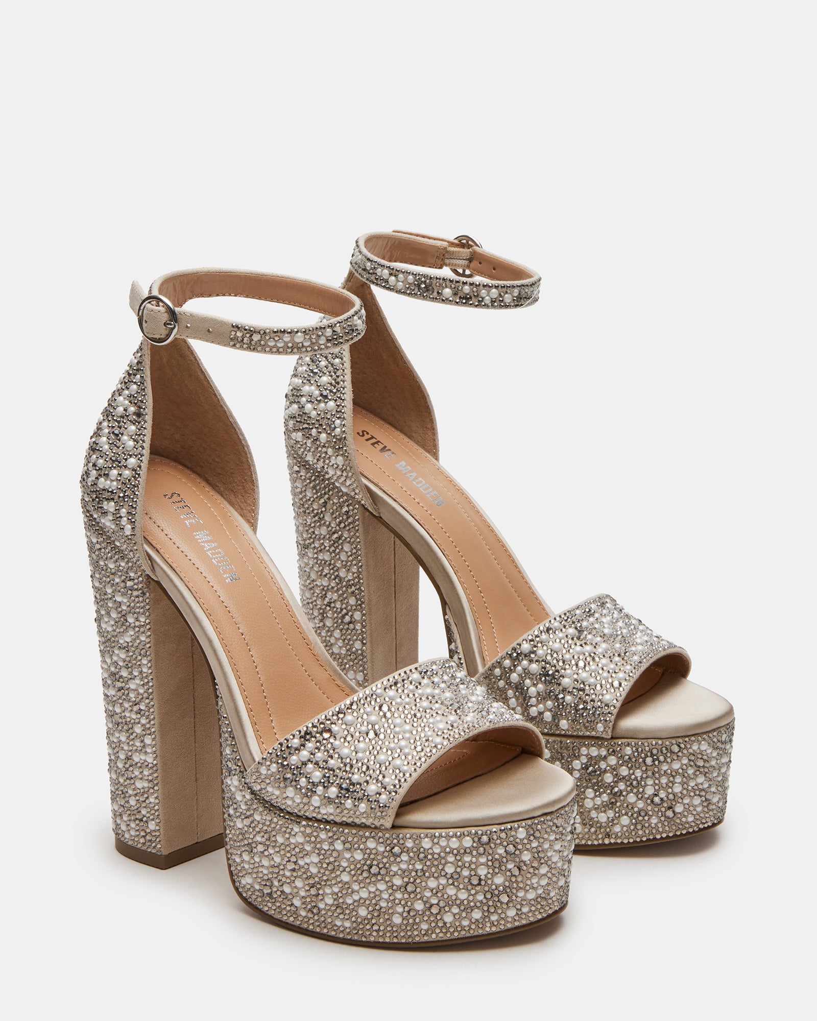 Close-up of GLAM ivory heels showing decorative stones and ankle strap