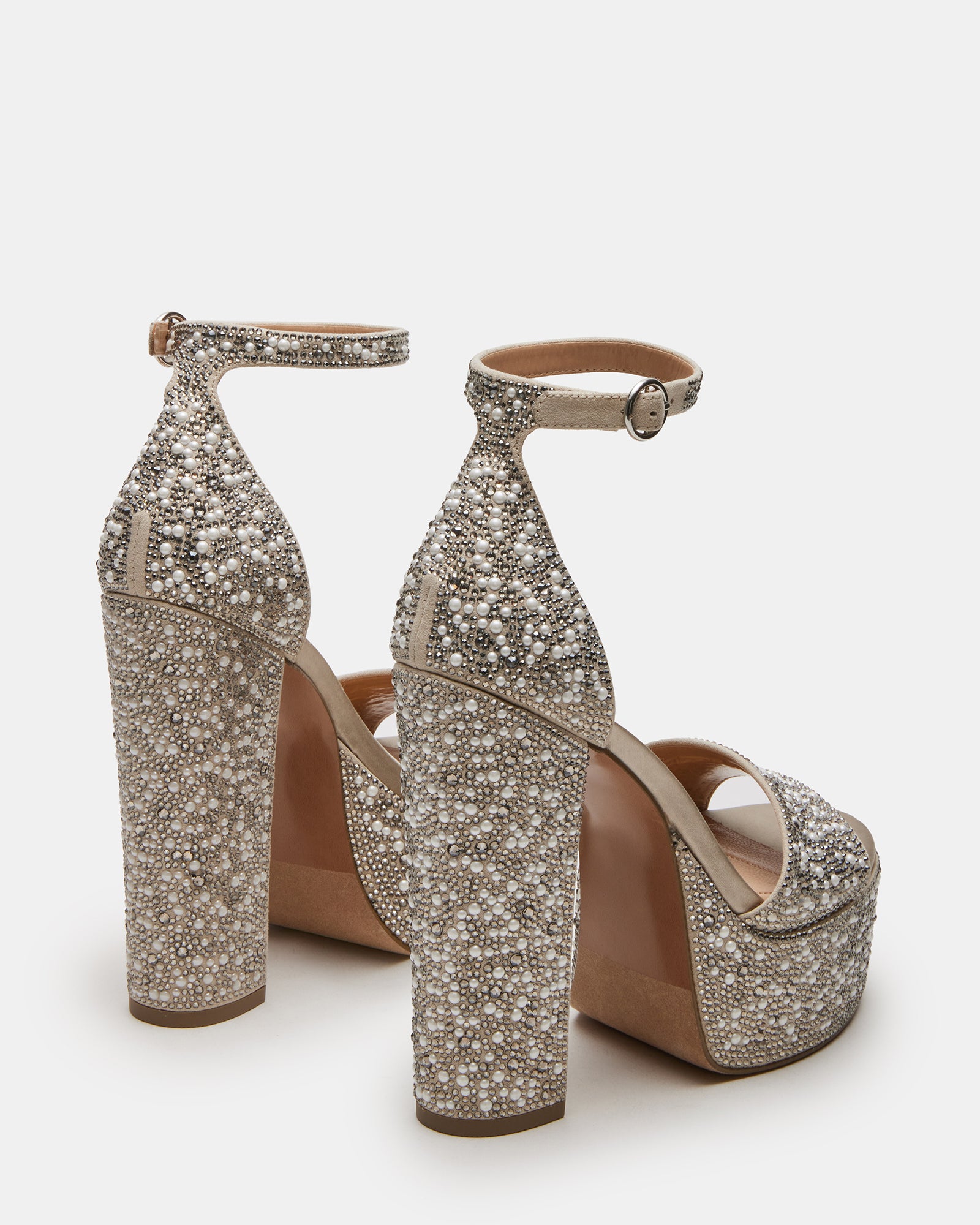 Close-up of GLAM ivory heels showing decorative stones and ankle strap