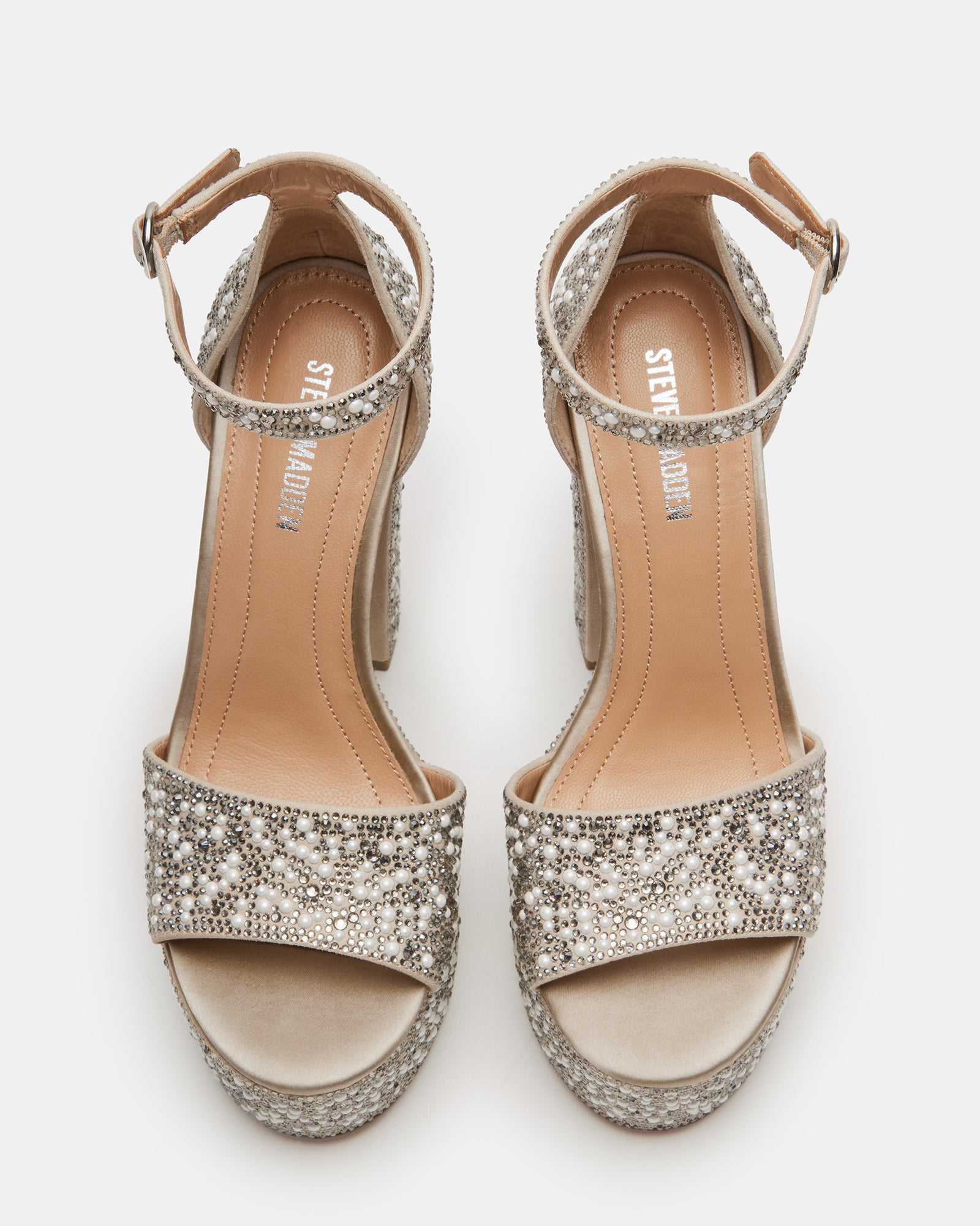 Ivory platform heels with ankle strap, worn with a black dress