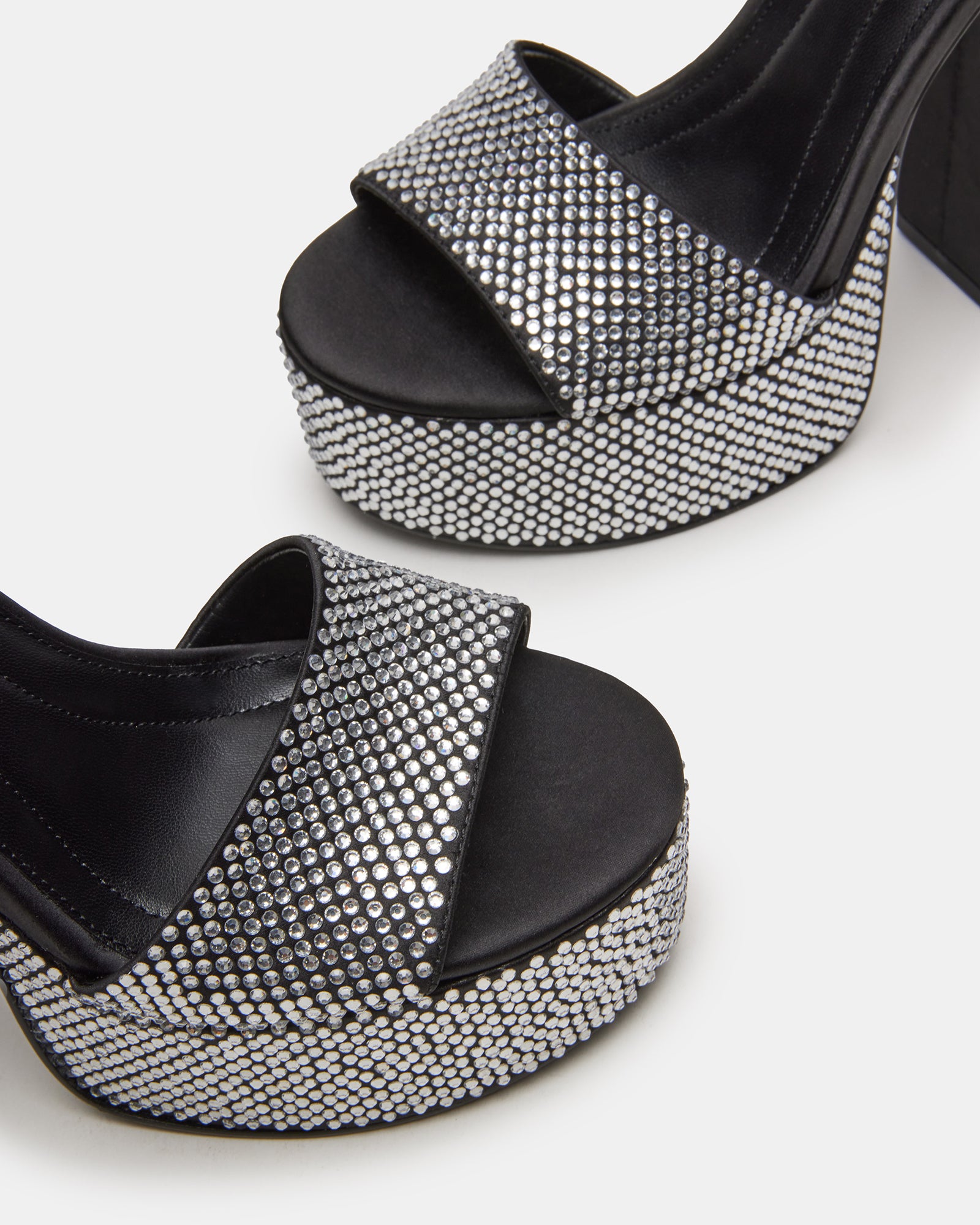 Close-up of black heels with black rhinestones, showcasing their elegant design.