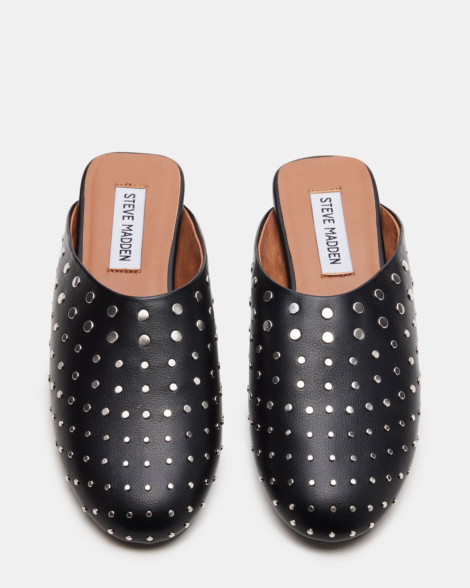 Black studded flat mules from a side angle, highlighting the stud details.