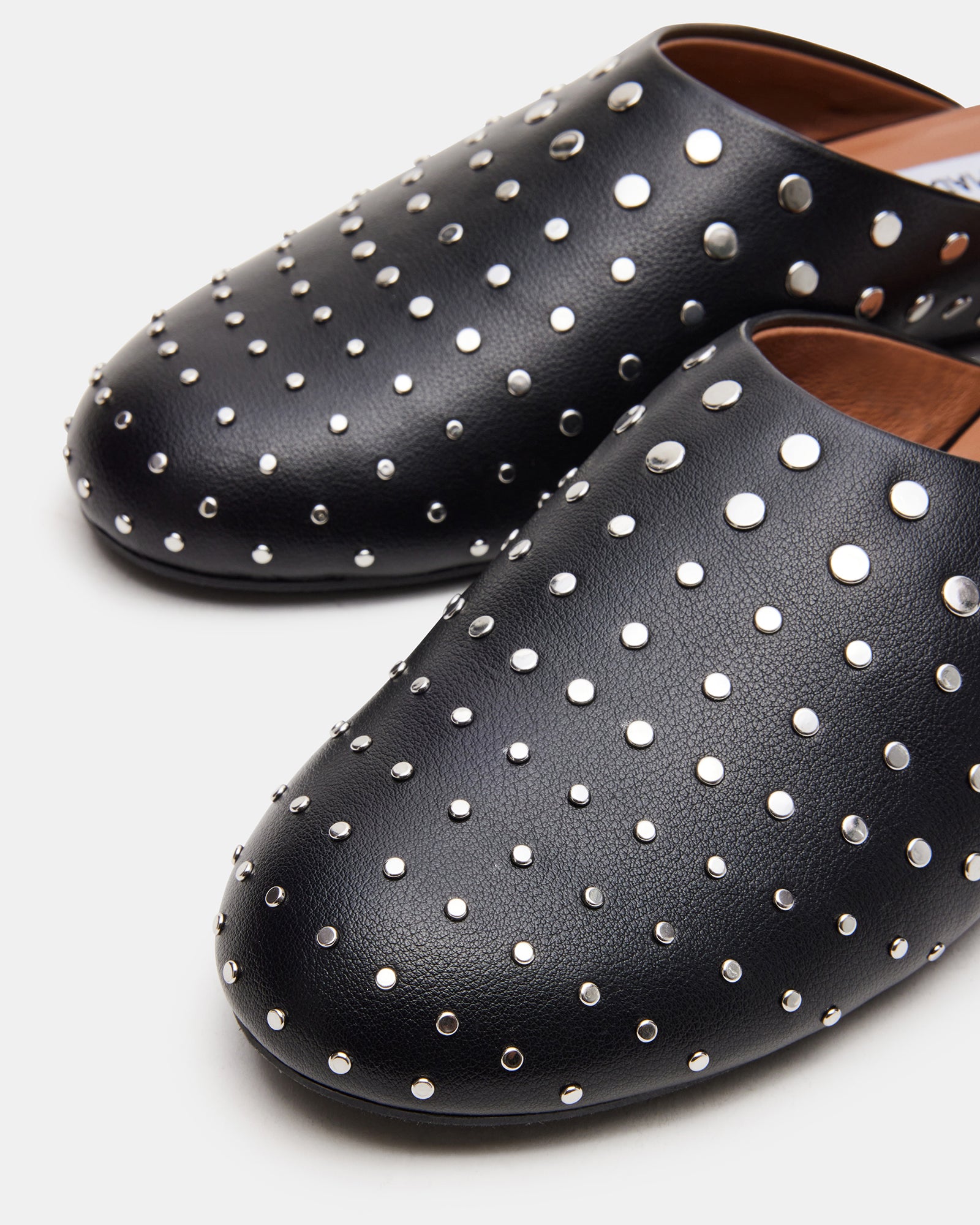 Glimmer stud shoes on a wooden surface, styled with casual denim.
