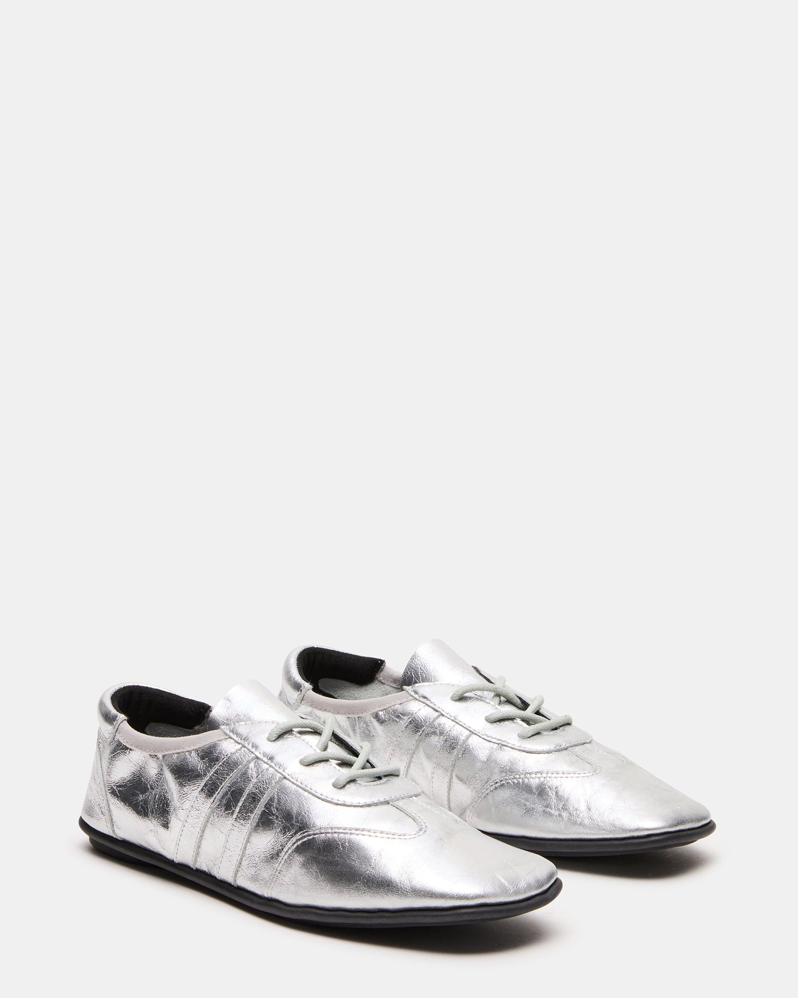 Top-down view showing textured finish of white leather sneakers men prefer for versatile looks