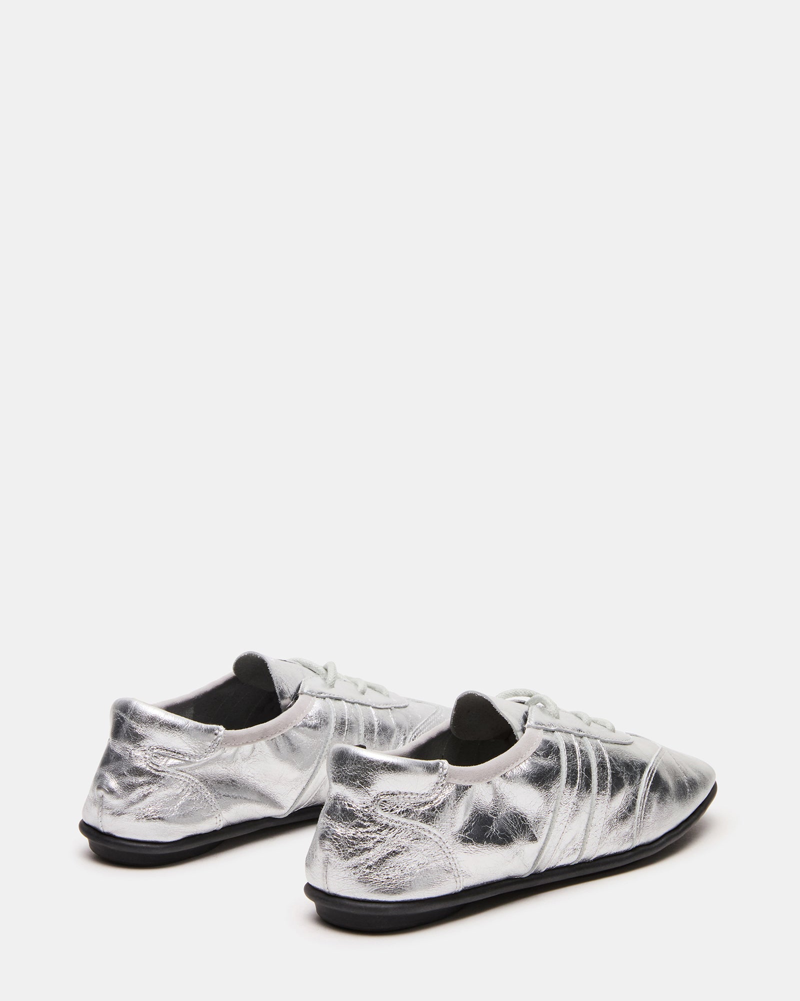 Top-down view showing textured finish of white leather sneakers men prefer for versatile looks