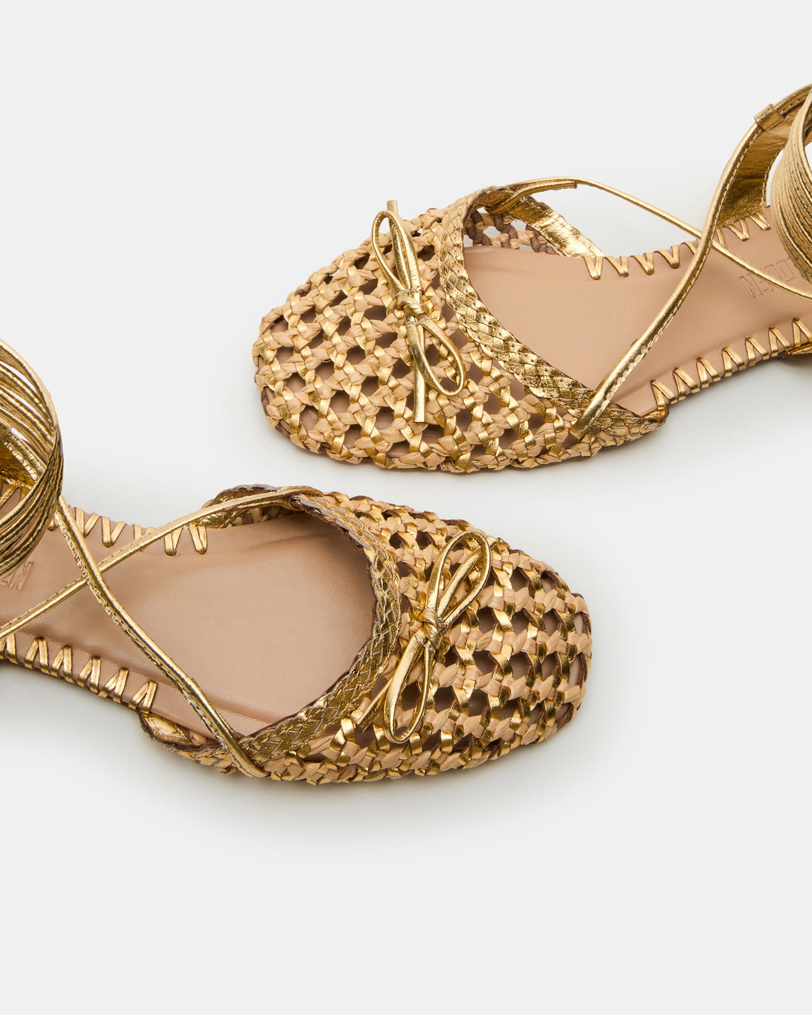 Top-down view of black ballet flats beside a travel-ready tote