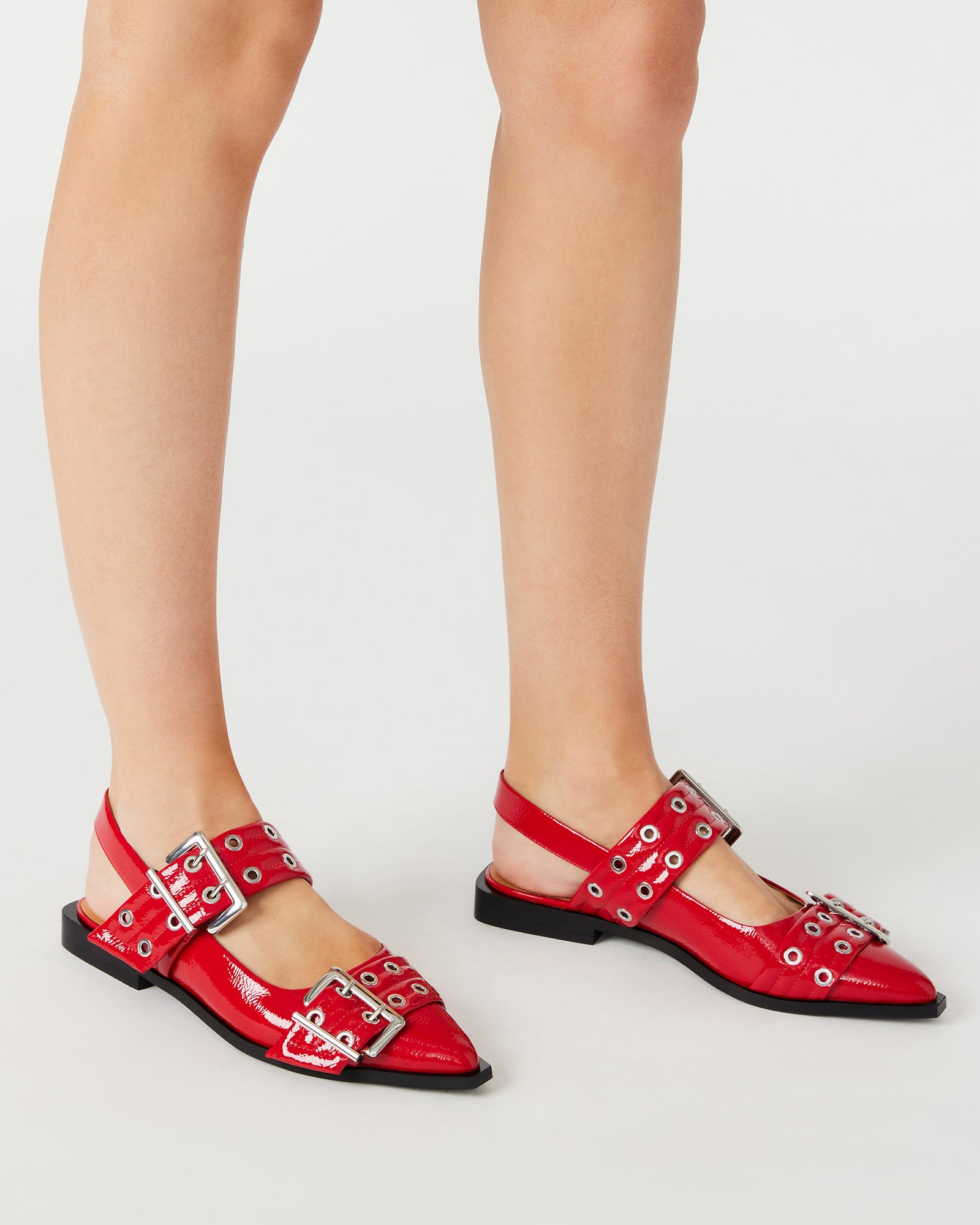 Close-up of snipped pointed toe and buckle detailing on these slingback flats.