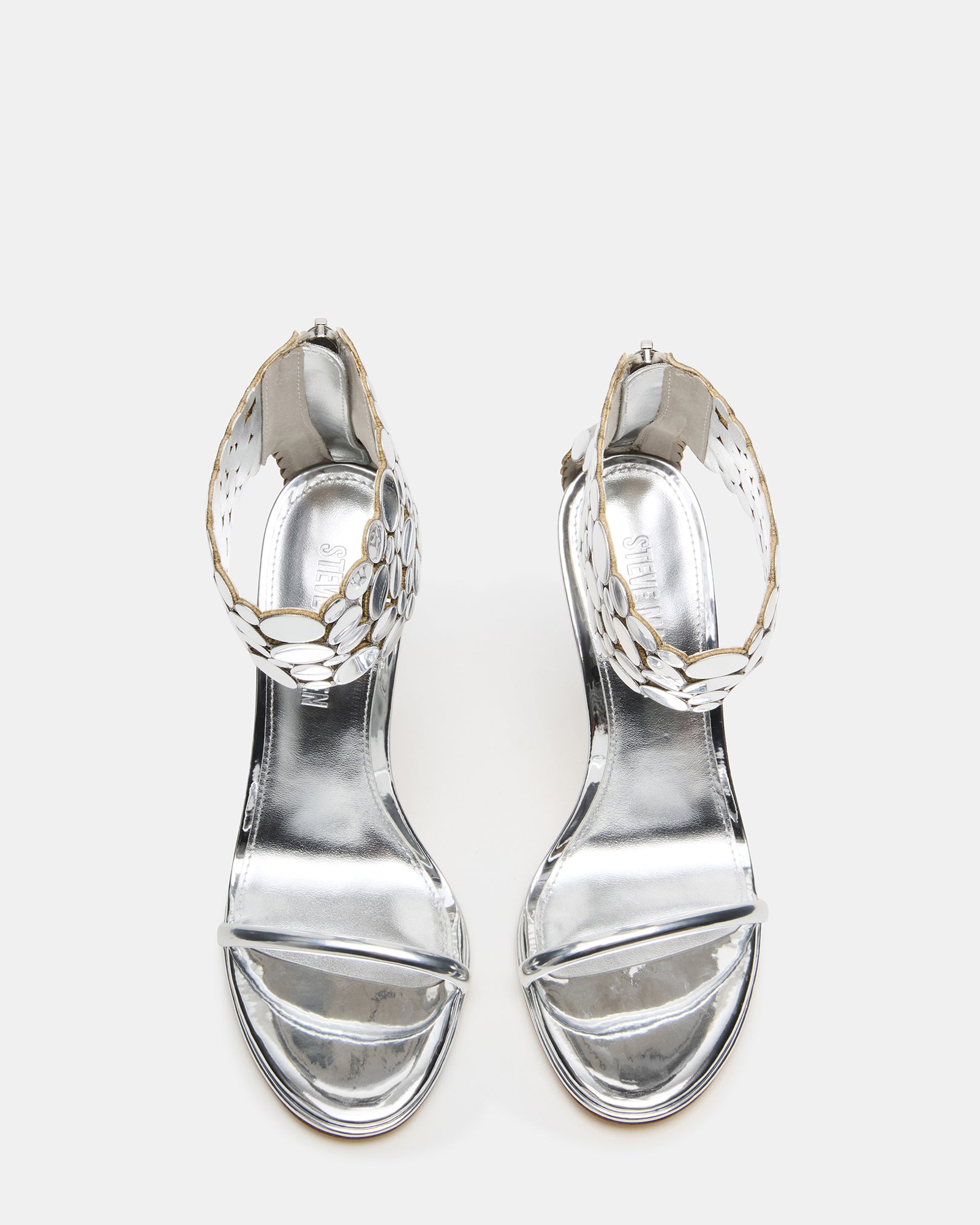 Silver GROOVI stiletto heels from the side, showcasing sleek design