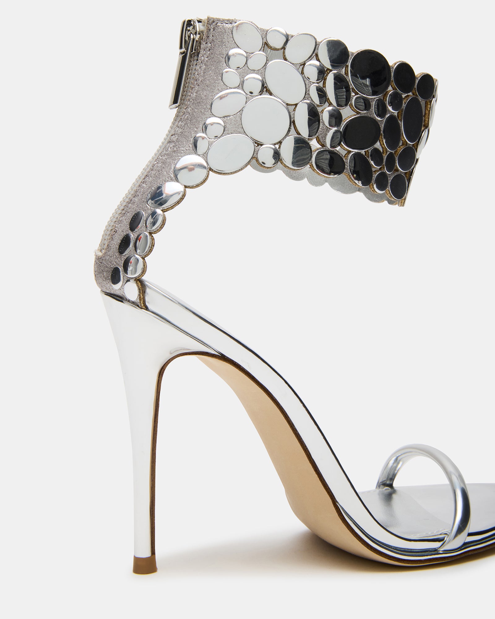 Model wearing silver stiletto heels with evening outfit
