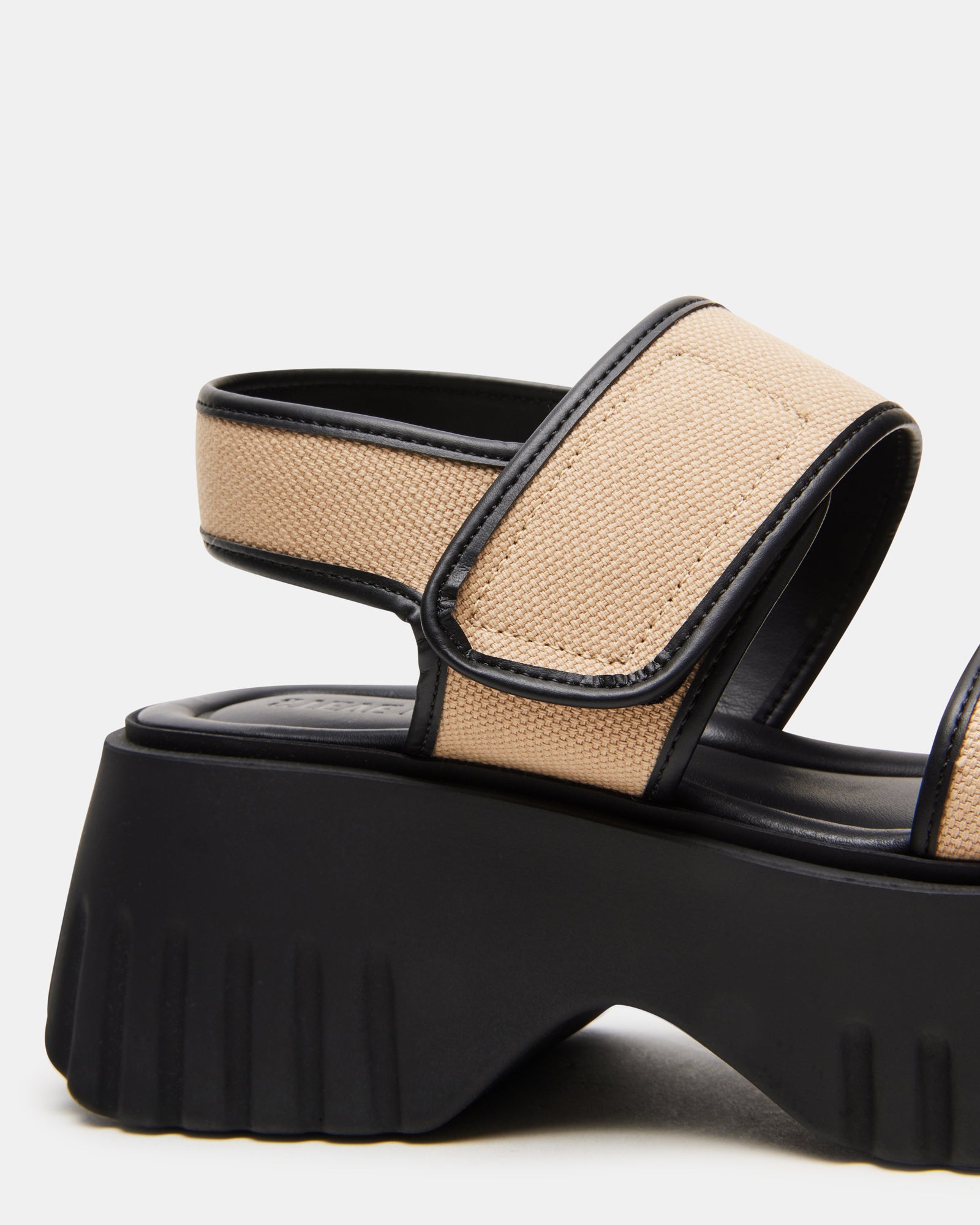 Black platform sandals styled with a summer dress, showcasing versatility.