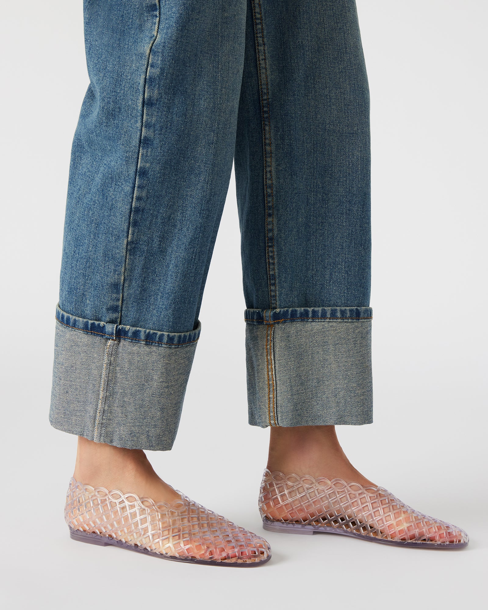 Lifestyle shot of jelly flats worn in casual spring outfit, on Texas sidewalk