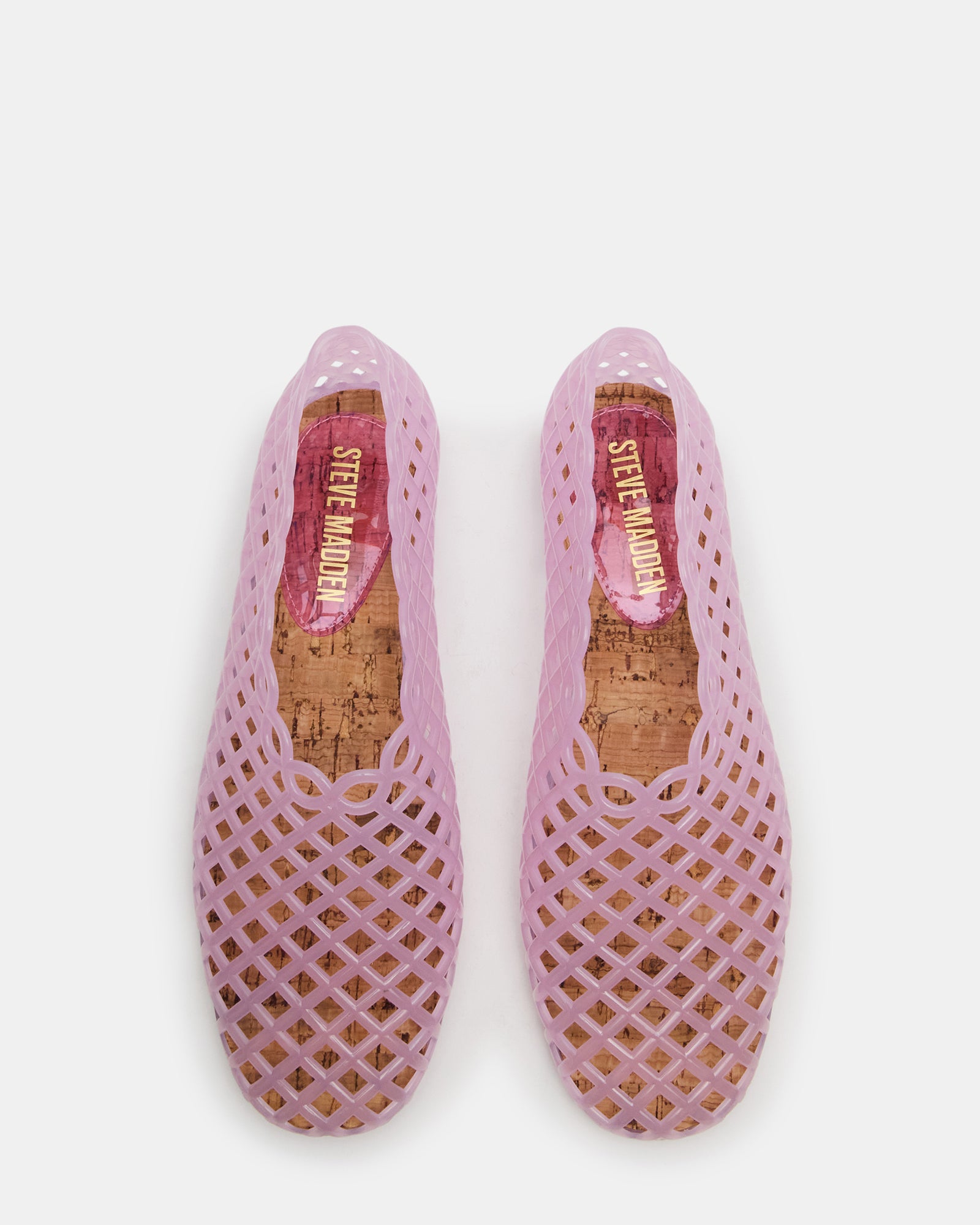 Close-up of clear jelly flats with square toe and blush pink finish