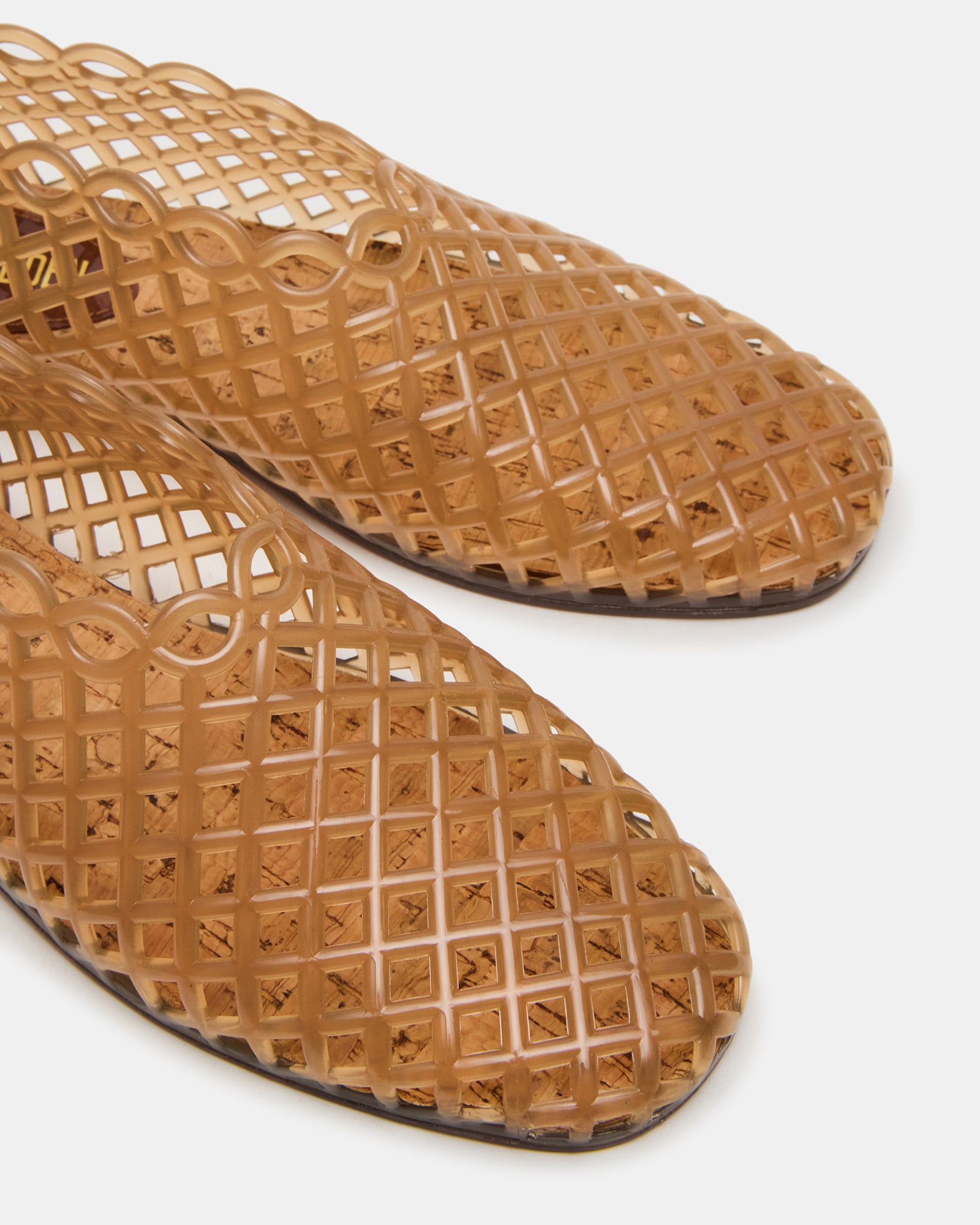 Top view of GroveTan jelly cage sandals showing square toe design on a sunny boardwalk