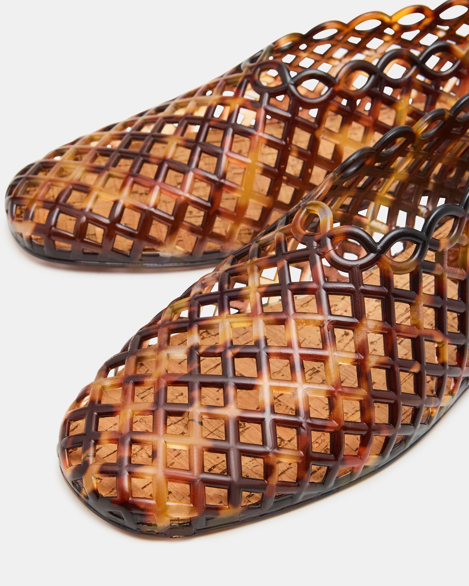 Side view of the black flat sandals featuring a square toe and jelly cage style