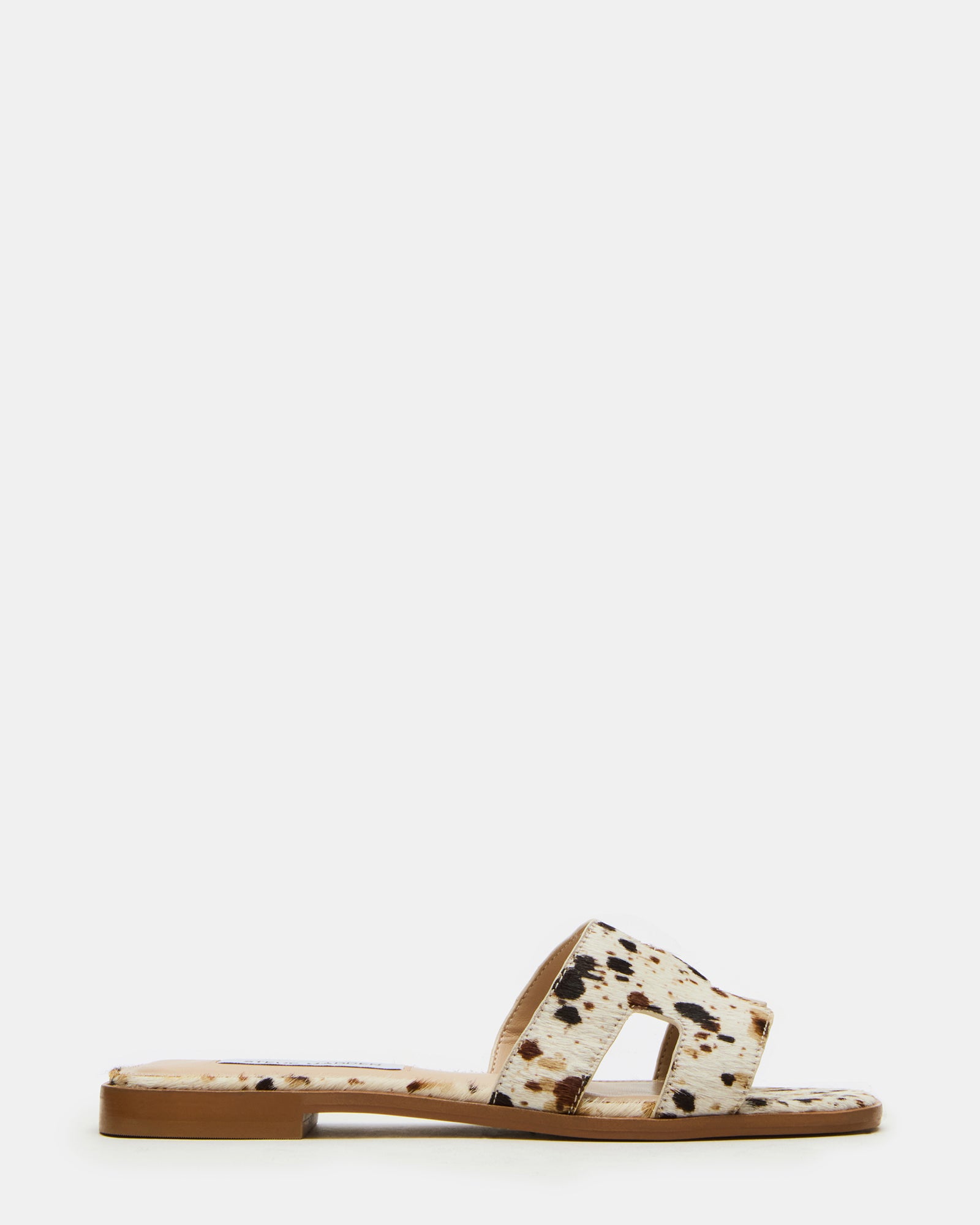 Side view of HADYN Tan Cow Print leather flat sandals with cutout details