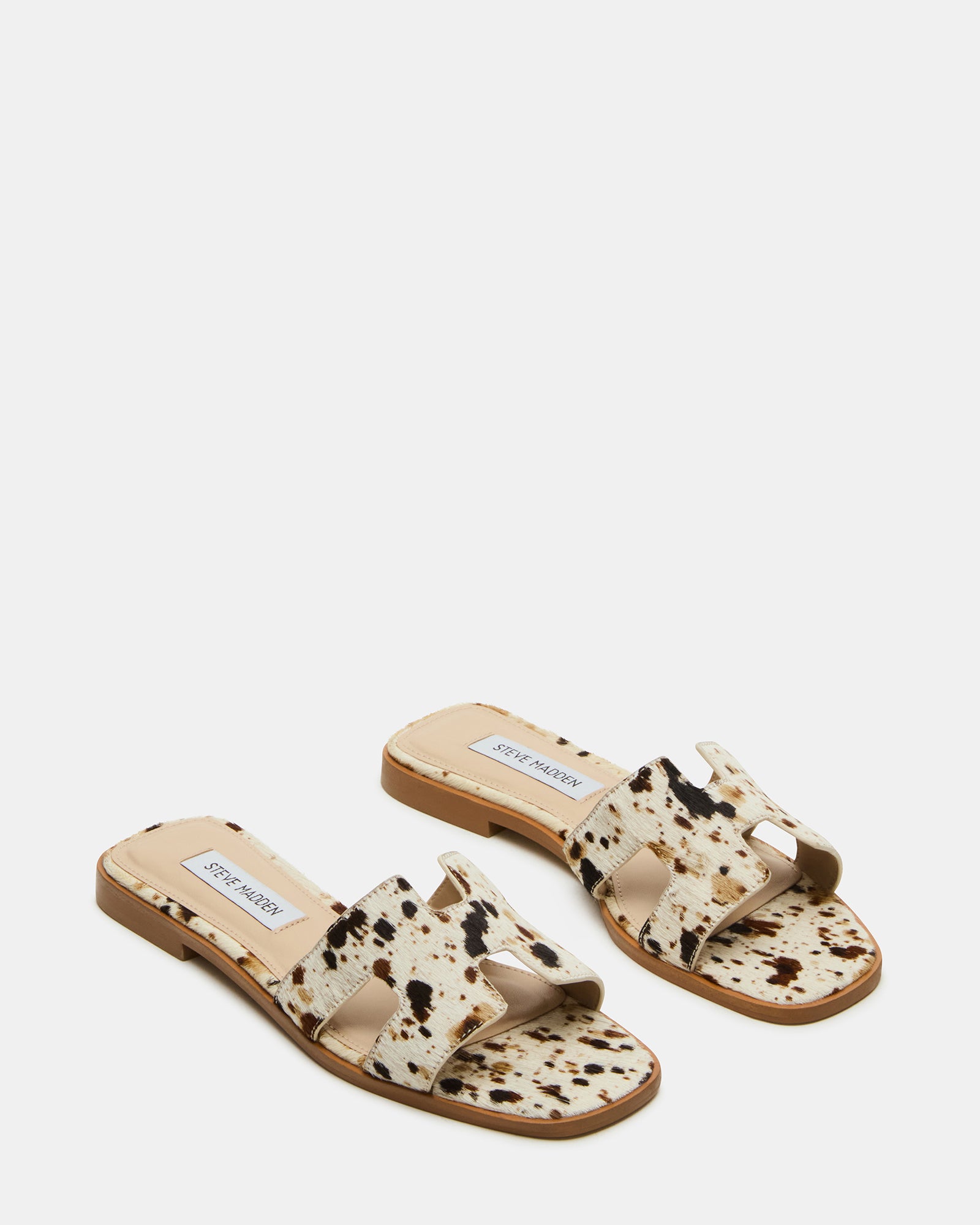 Close-up of the geometric cutouts on the strap of the HADYN slide sandals
