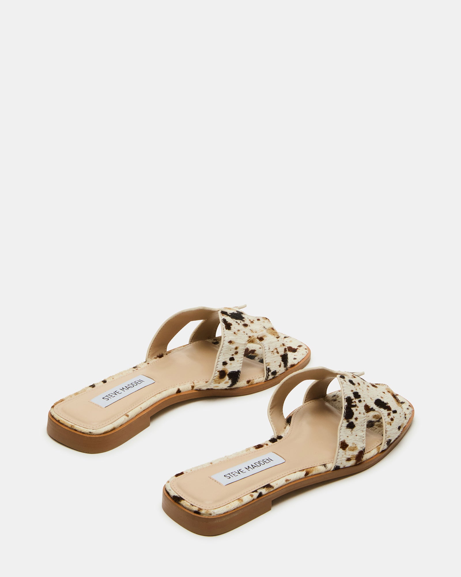Close-up of the geometric cutouts on the strap of the HADYN slide sandals
