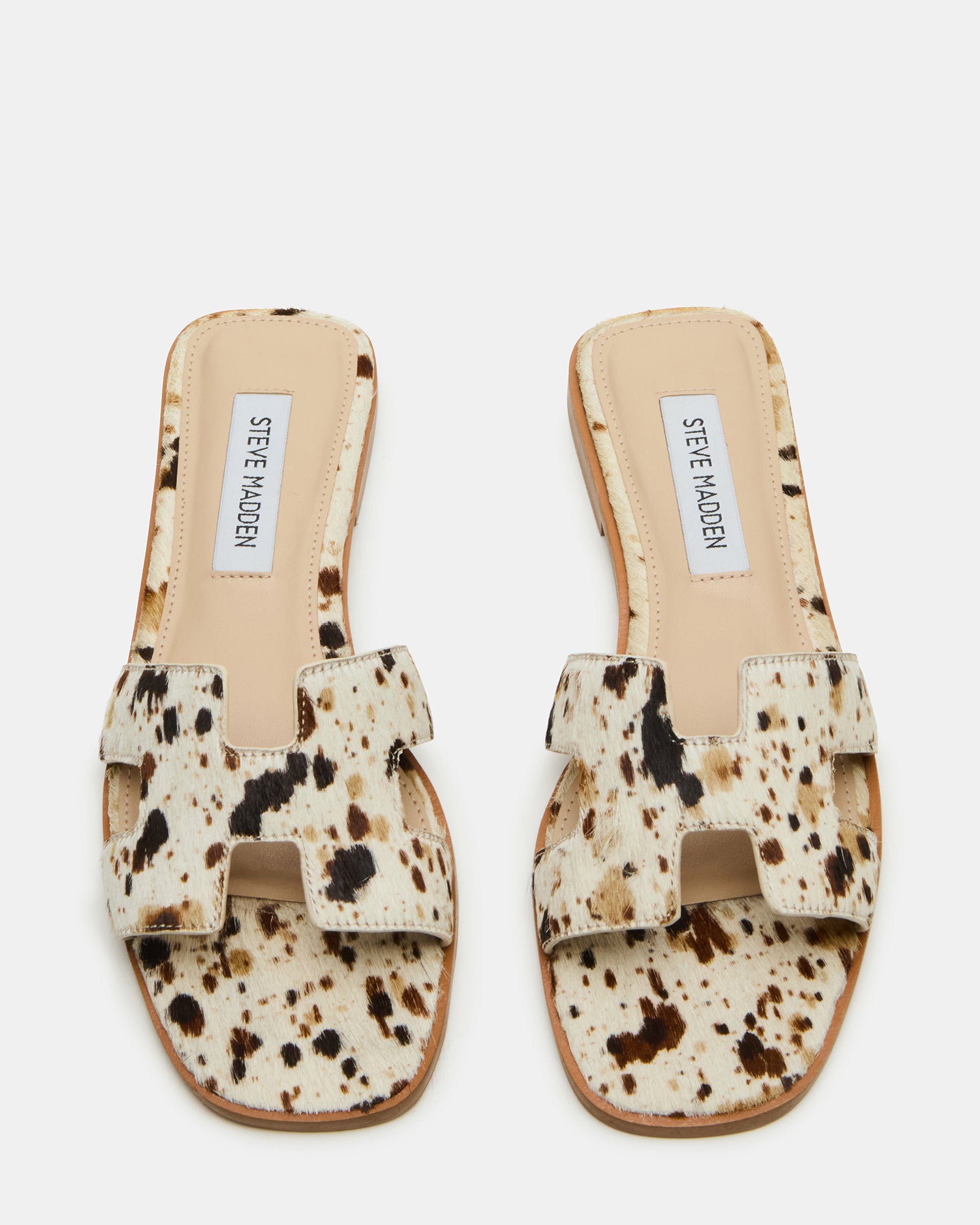 Side view of HADYN Tan Cow Print leather flat sandals with cutout details