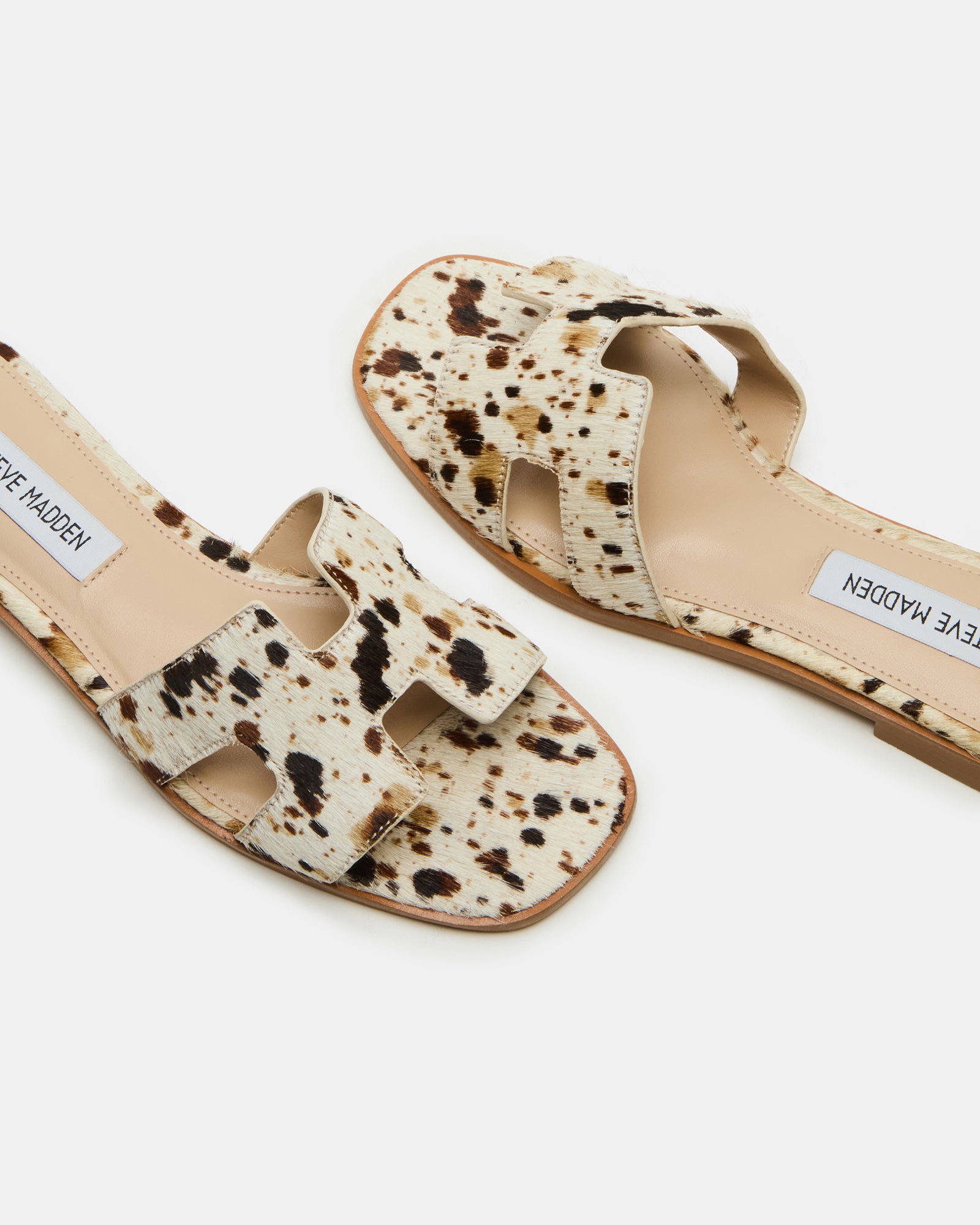 Styled outfit featuring HADYN leather flat sandals with cow print for summer outings