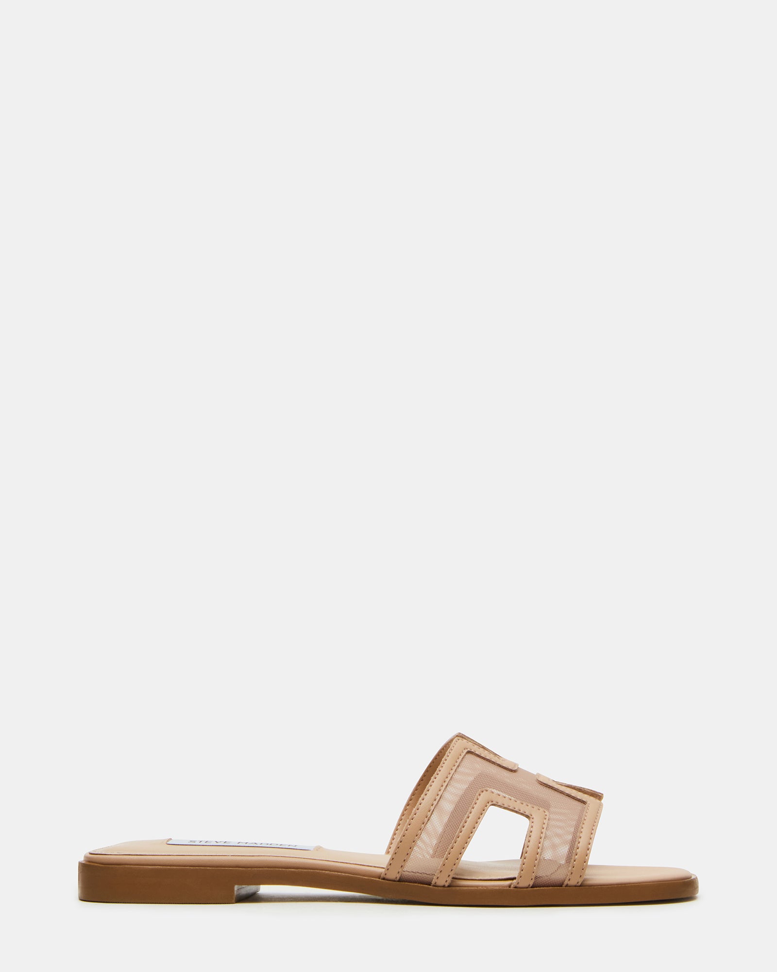 Close-up of gold flat sandals highlighting cutout strap detail