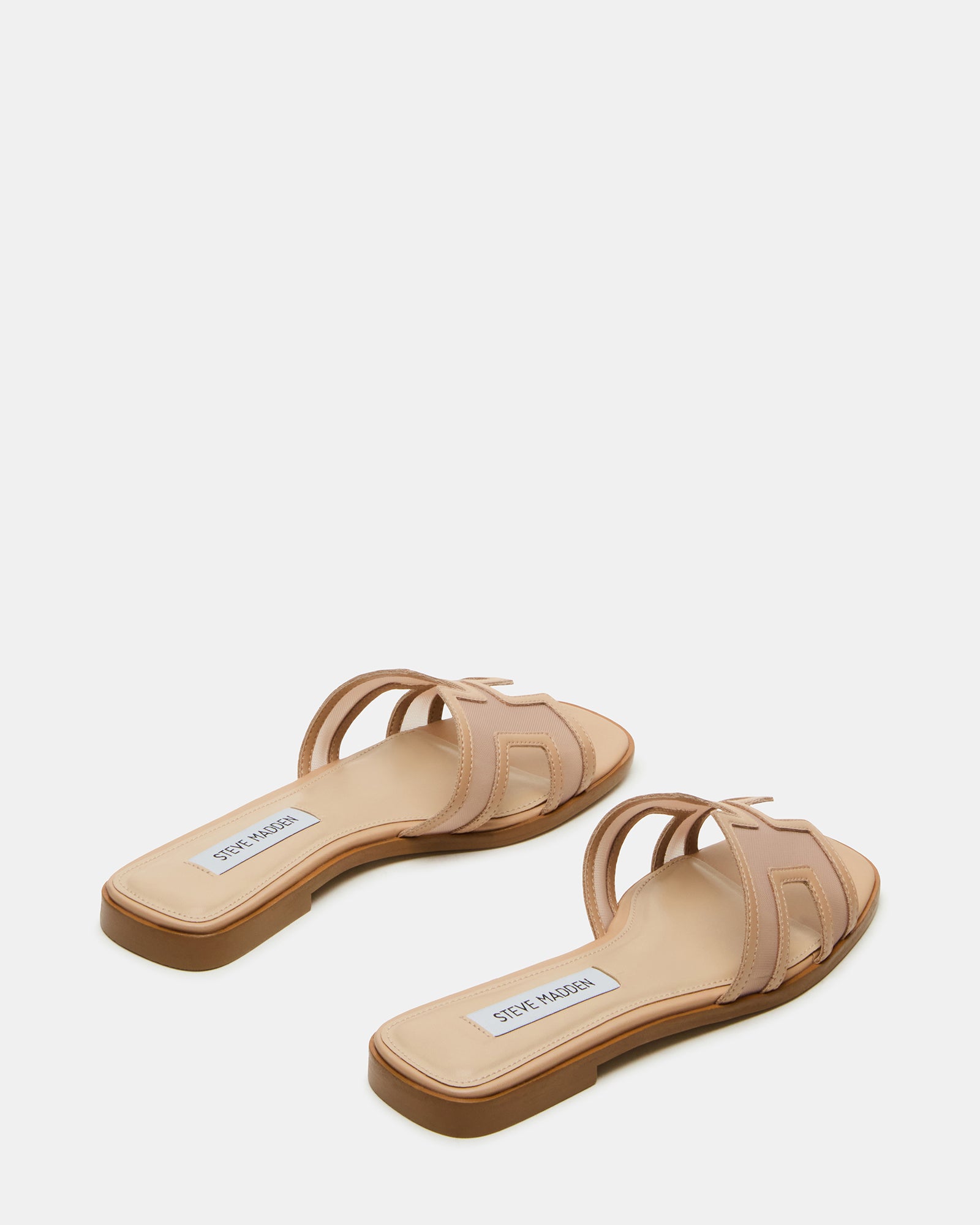 Woman wearing flat sandals on sunny California boardwalk, casual styling