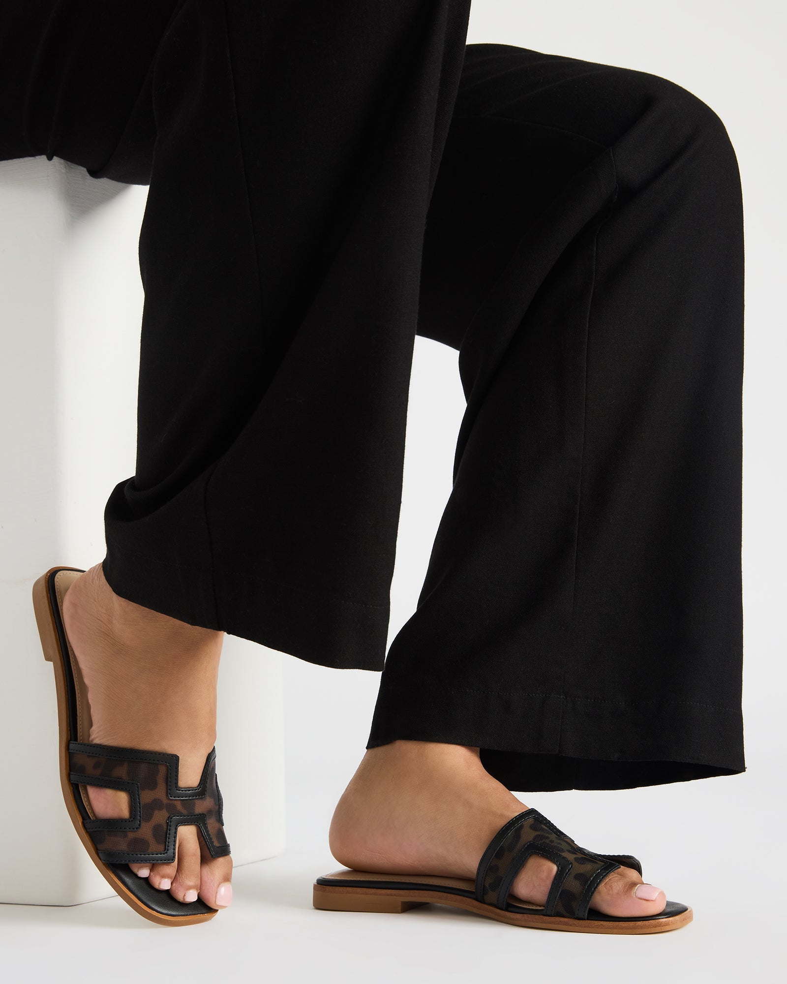Top-down shot of the slip-on casual sandals on a models feet