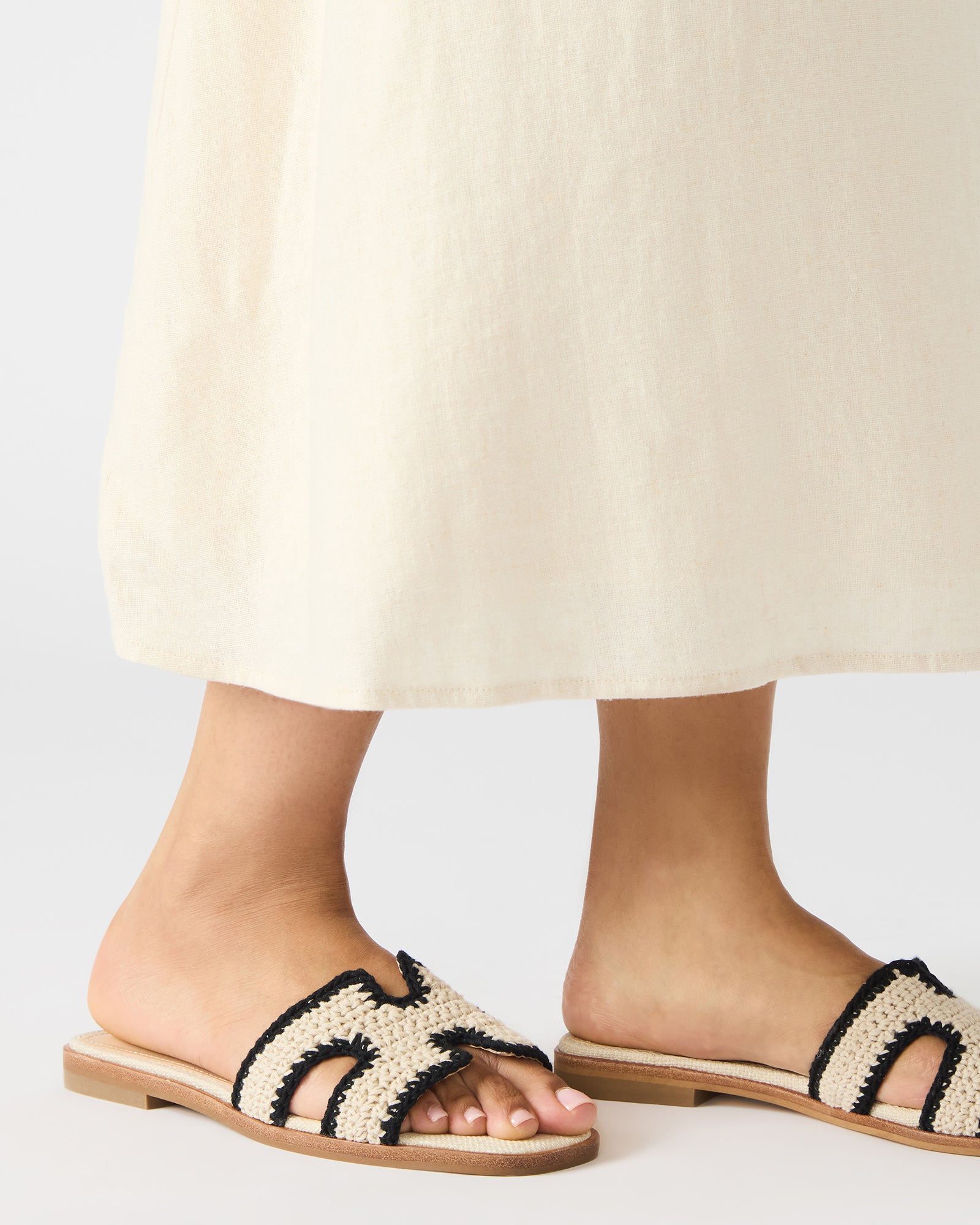 Cream multi sandals on feet, styled with casual summer outfit