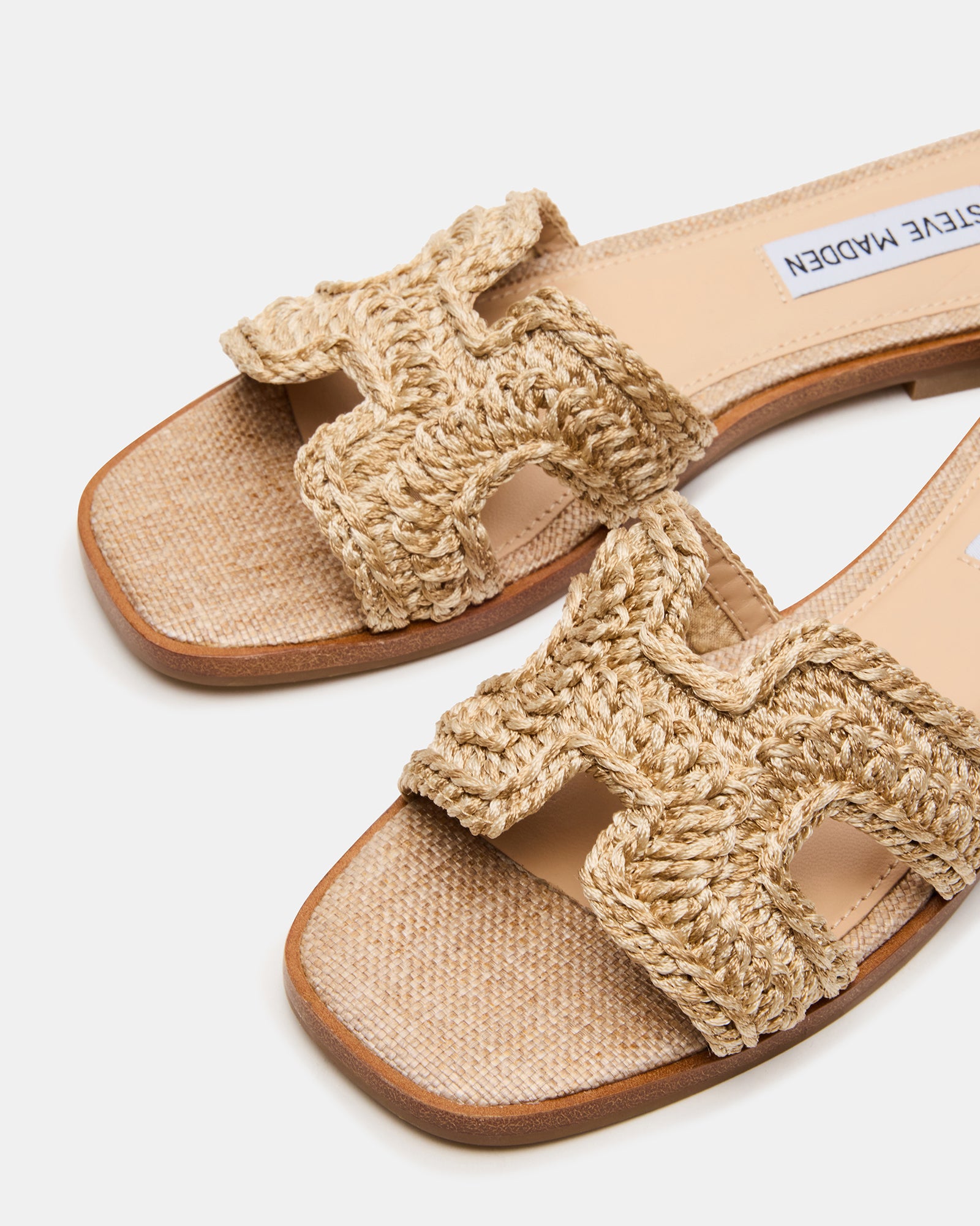 Hadyn slide sandals side view showcasing raffia texture and geometric cutouts