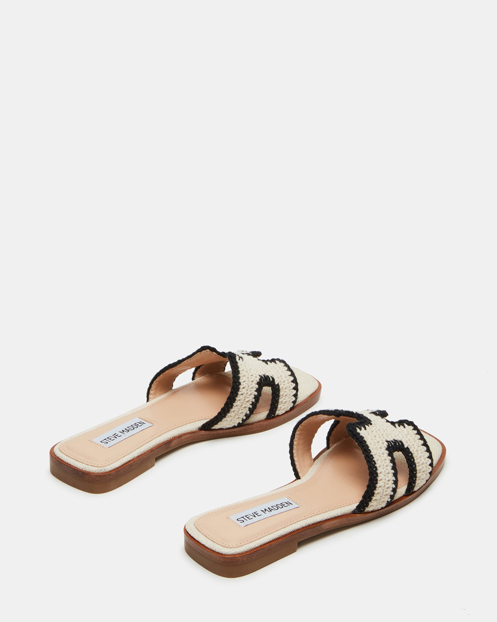 Close-up of geometric cutouts on brown sandals for women flat