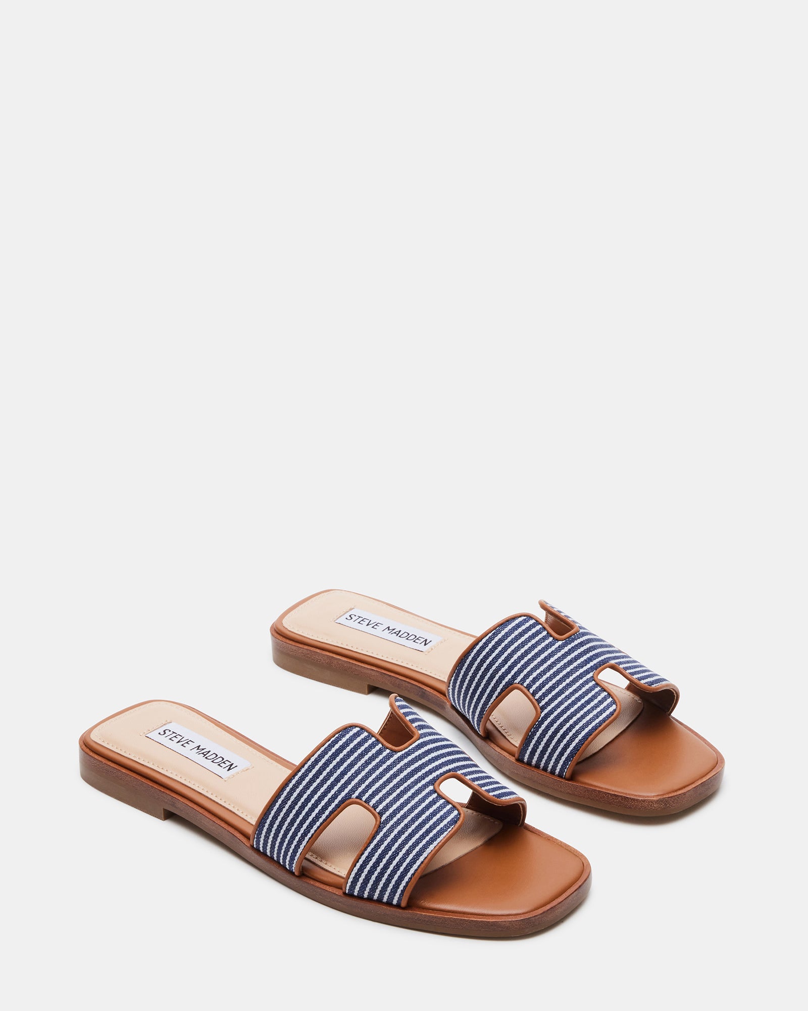 Side view of slip-on flat sandals with synthetic sole and heel