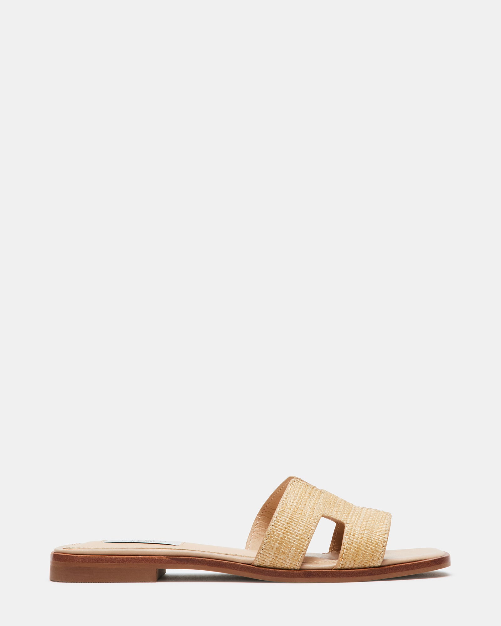 Side view of HADYN Raffia platform slides with geometric cutouts on a sunny outdoor setting