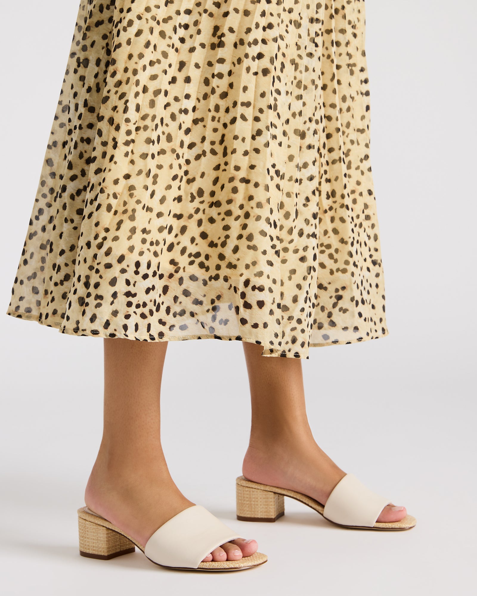 Elegant chestnut suede mule sandals worn at a casual event