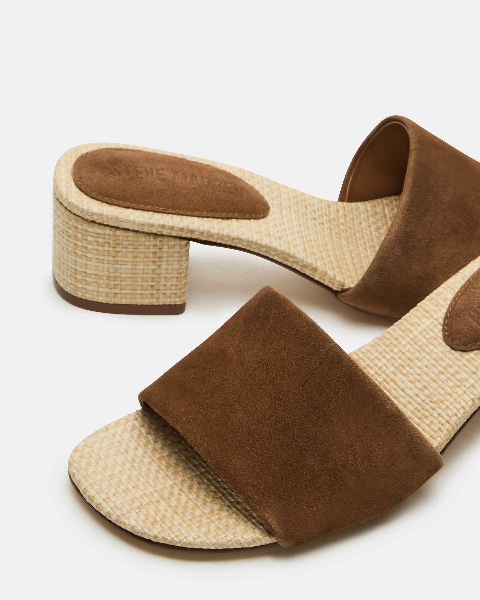 Elegant chestnut suede mule sandals worn at a casual event