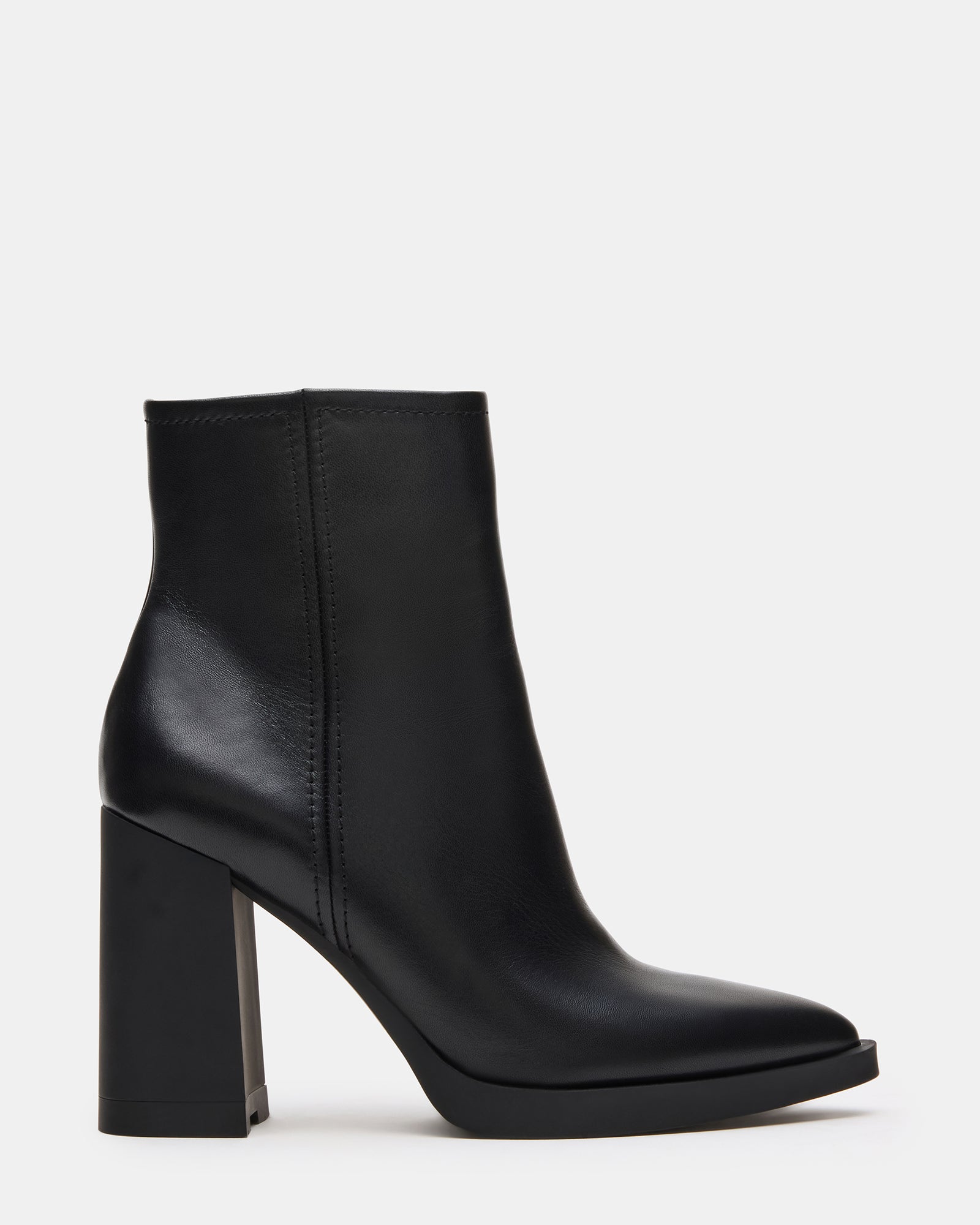 Black suede ankle boots styled with cuffed jeans for a casual look.