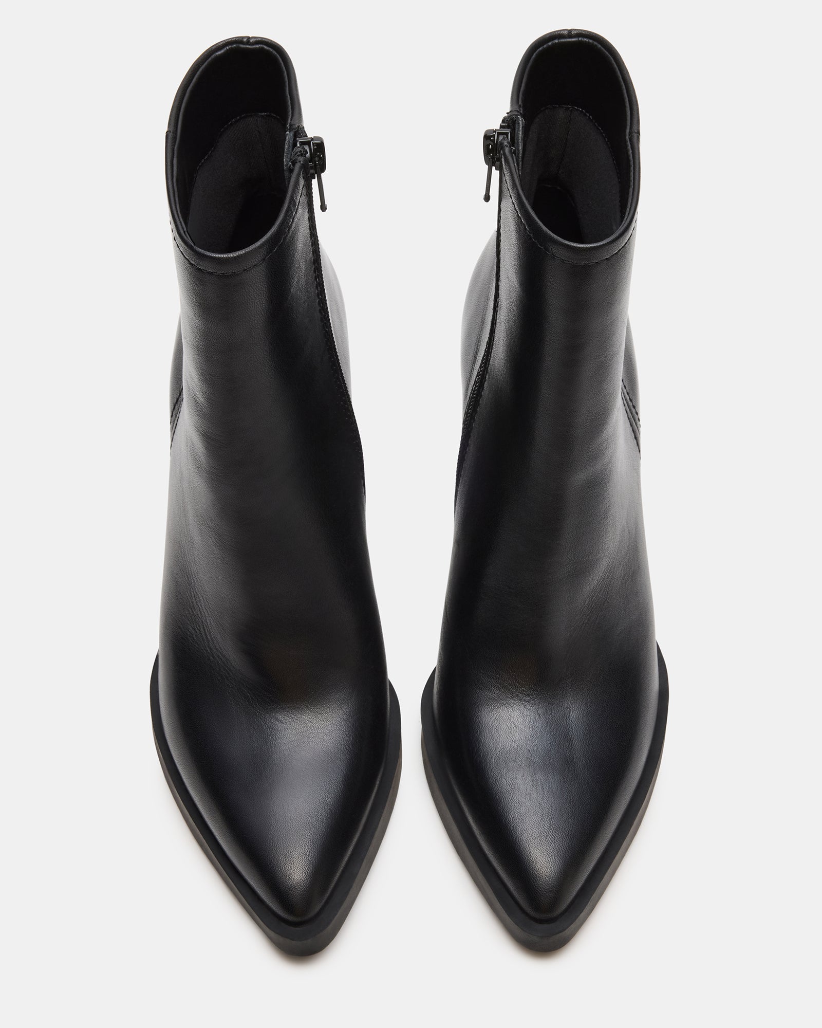 Leather chelsea booties worn with a midi dress for evening elegance.