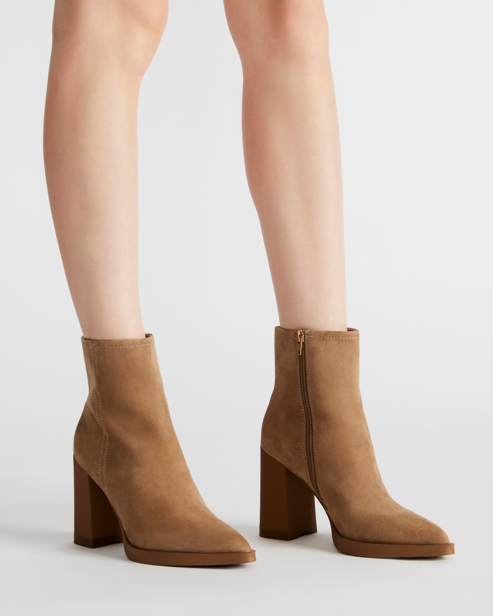Close-up of the pointed toe and block heel of the suede booties.