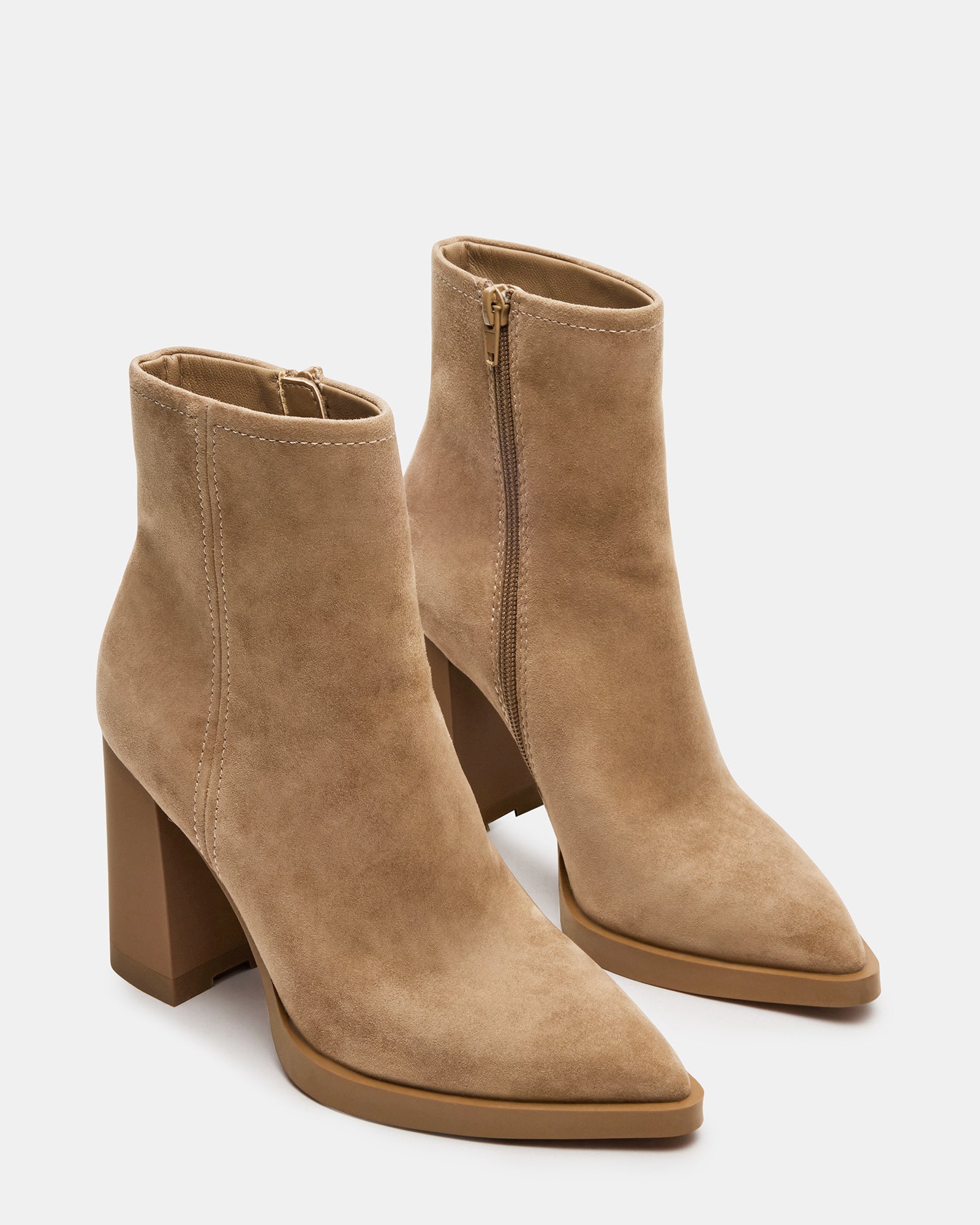 Model wearing brown suede ankle booties paired with casual attire.