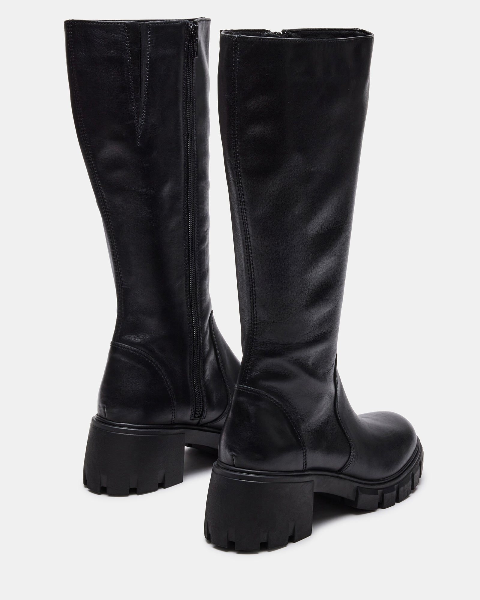 Close-up of lug sole treads on black leather boots
